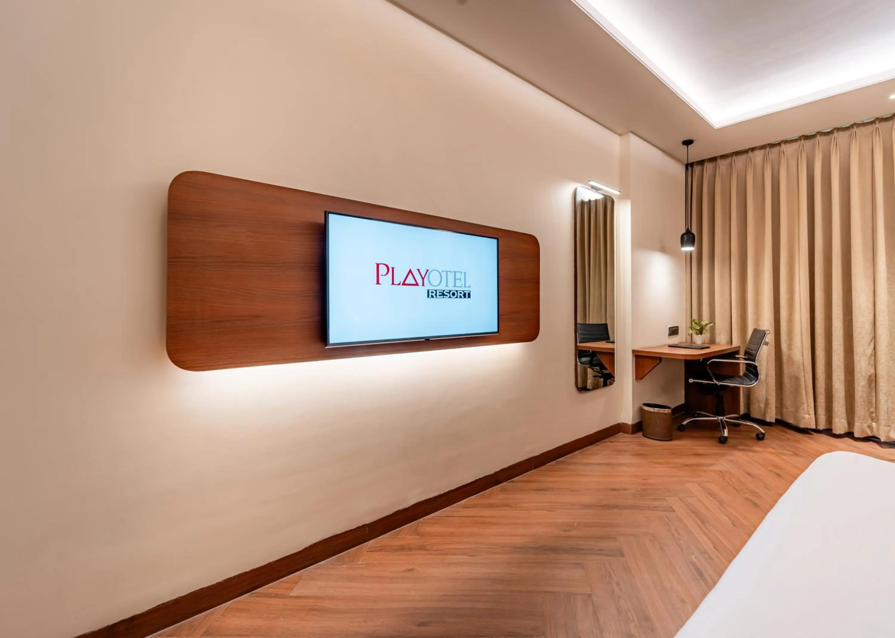 Communal lounge/ TV room, Bed in Playotel Resort Bhopal