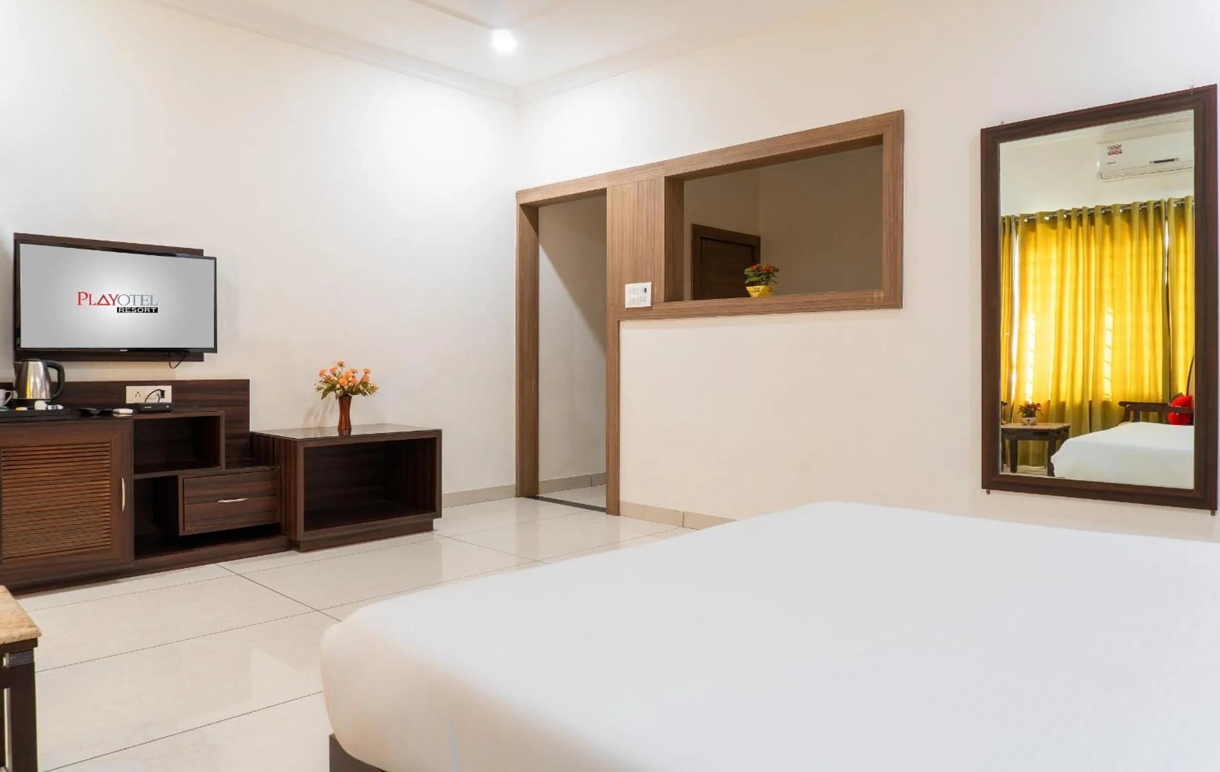 Communal lounge/ TV room, Bed in Playotel Resort Bhopal