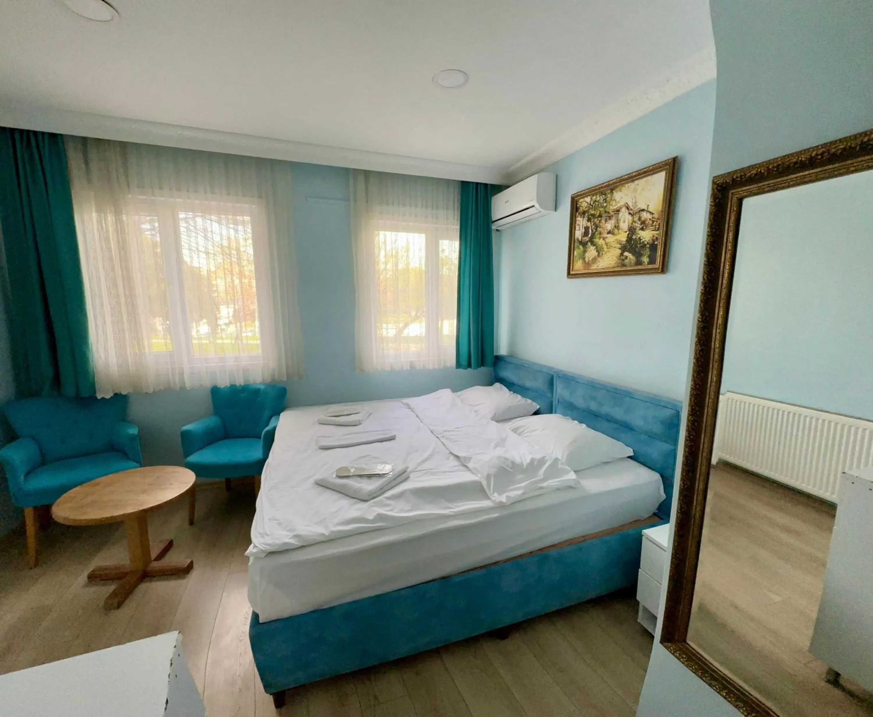 Bed in AVRASYAQUEEN HOTEL