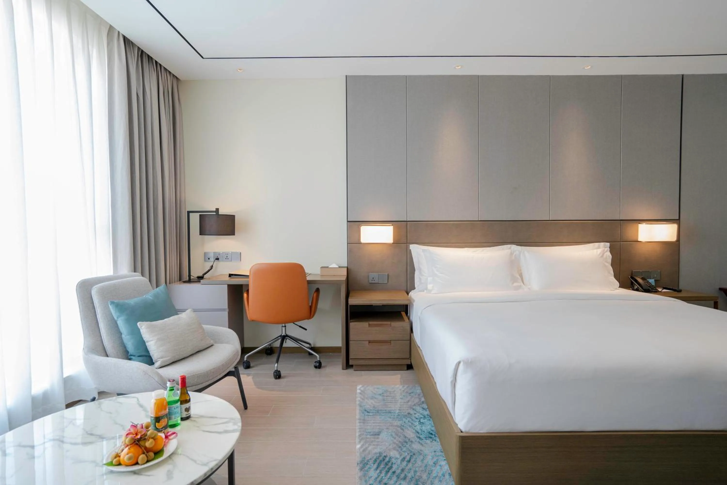 Seating area, Bed in Oakwood Premier Phnom Penh