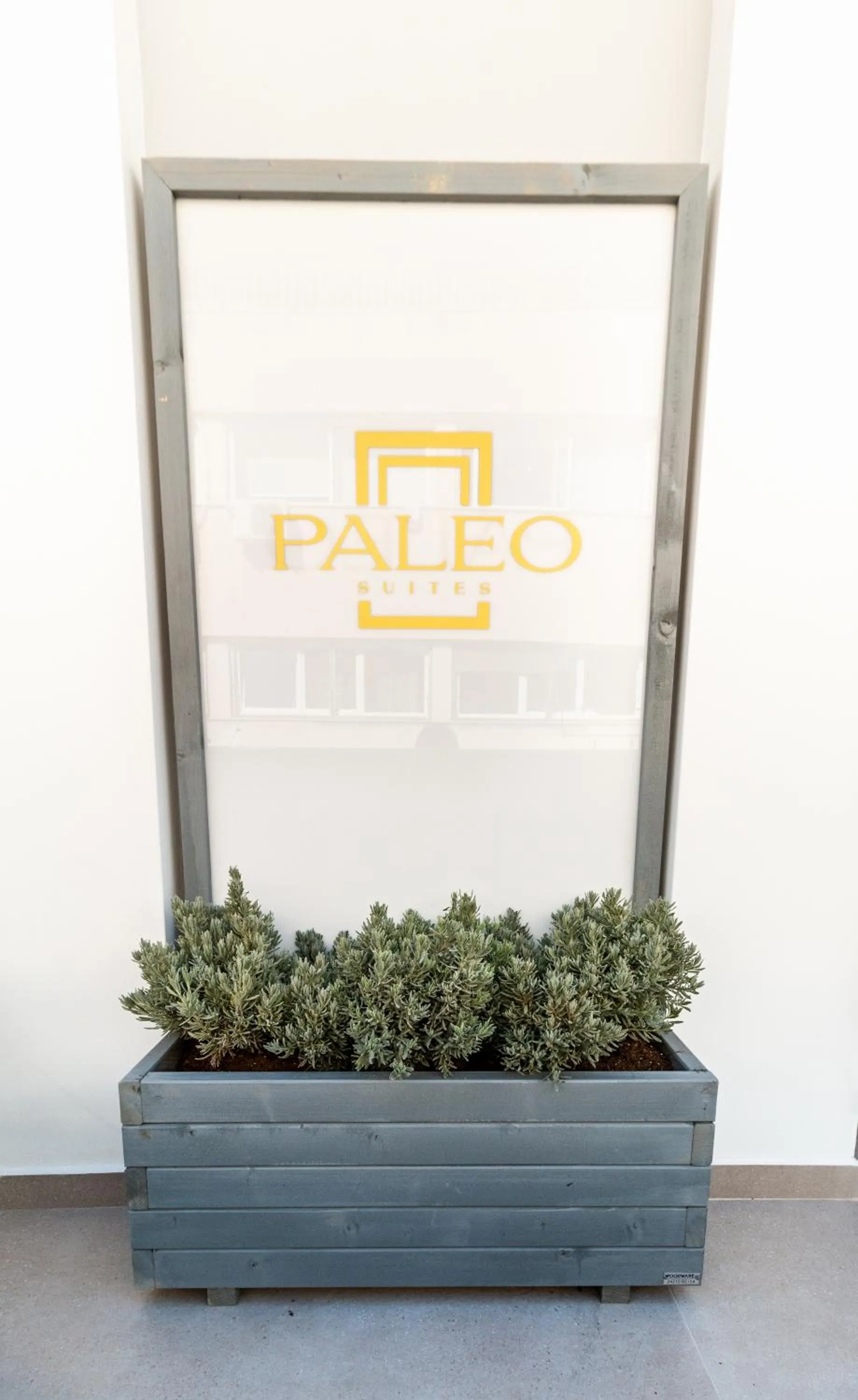 Property logo or sign in Paleo Suites