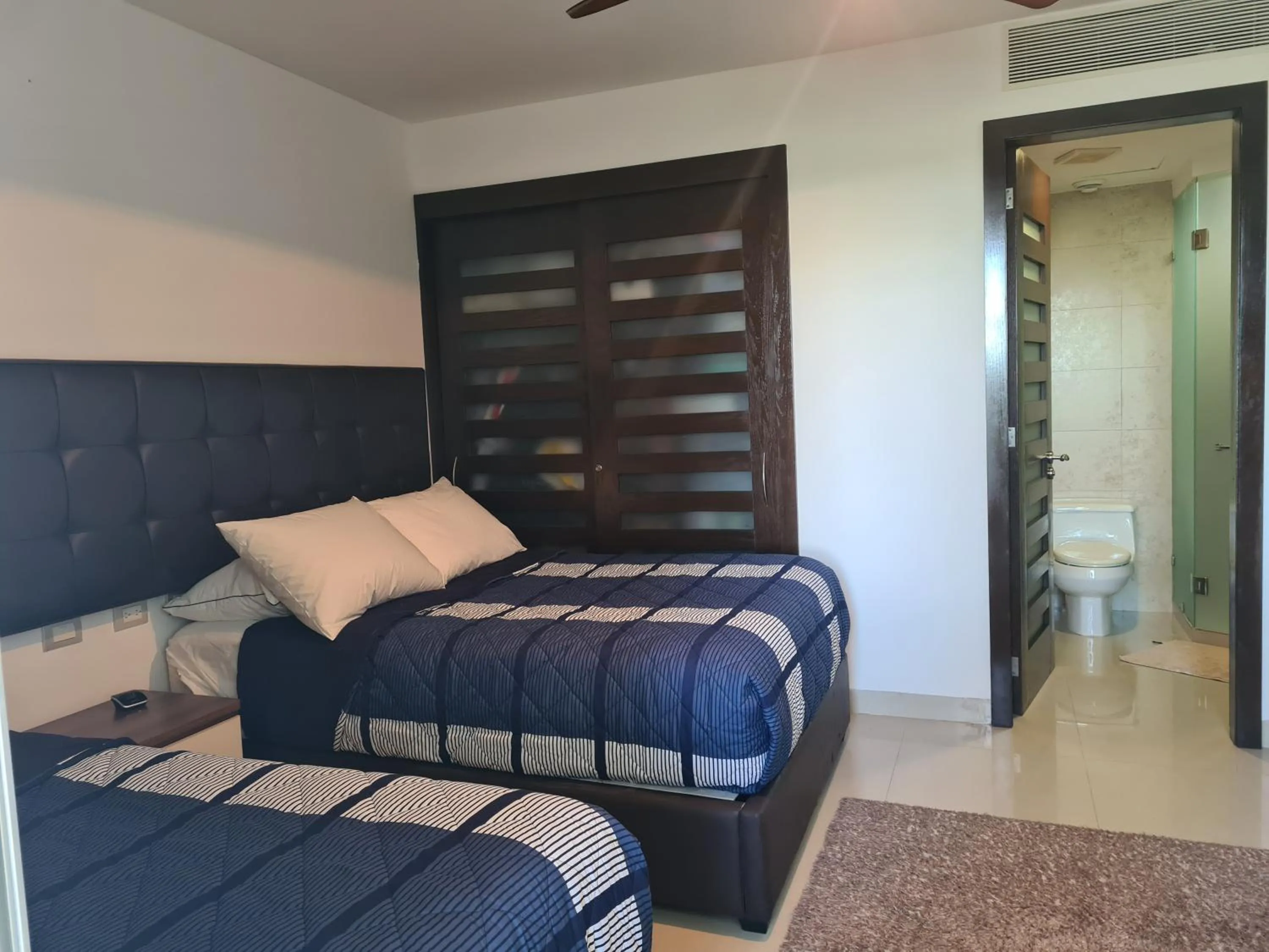 Bed in Luxury ocean view penthouse and private beach club