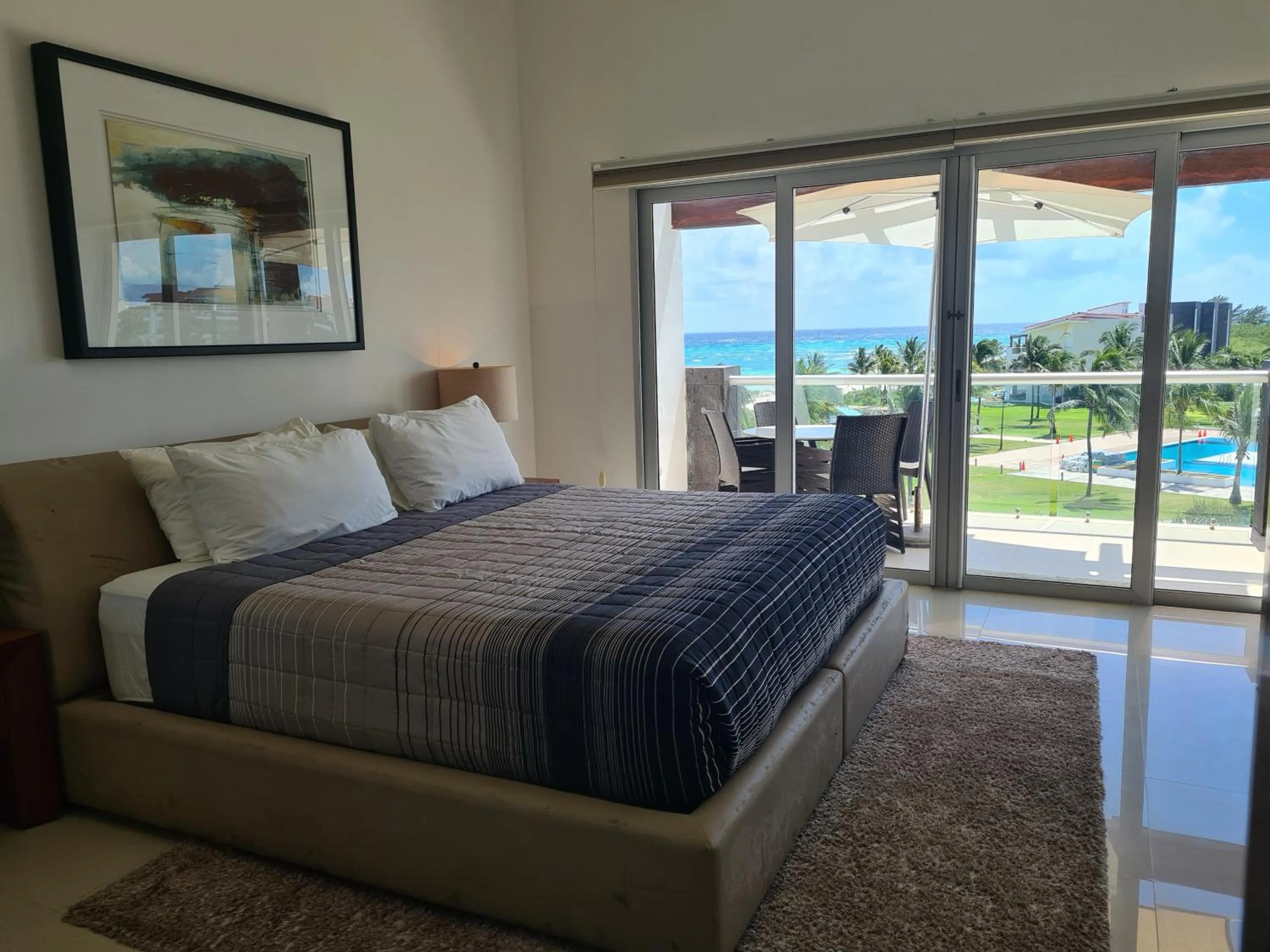 Bed in Luxury ocean view penthouse and private beach club