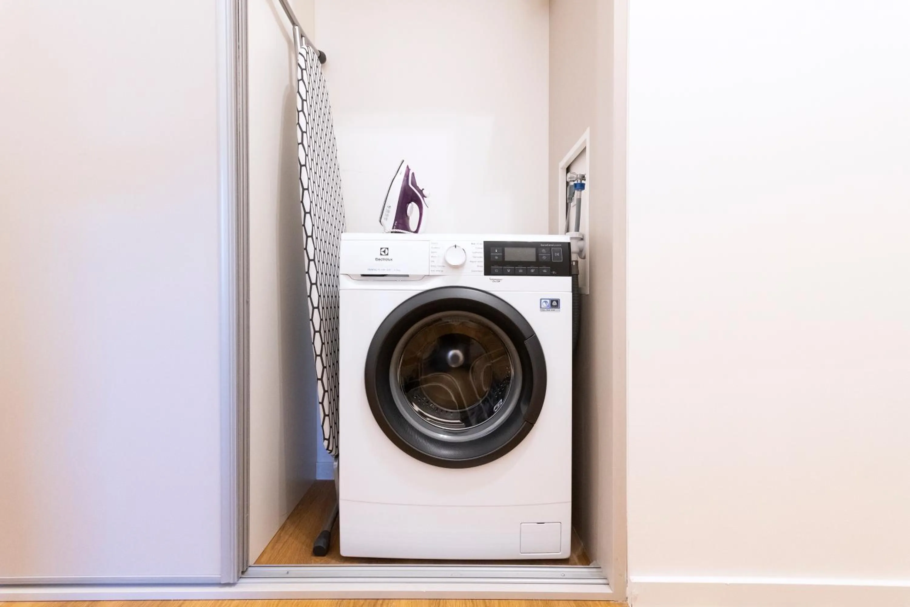 washing machine in Hidden Art Boutique Residence by Dwellfort