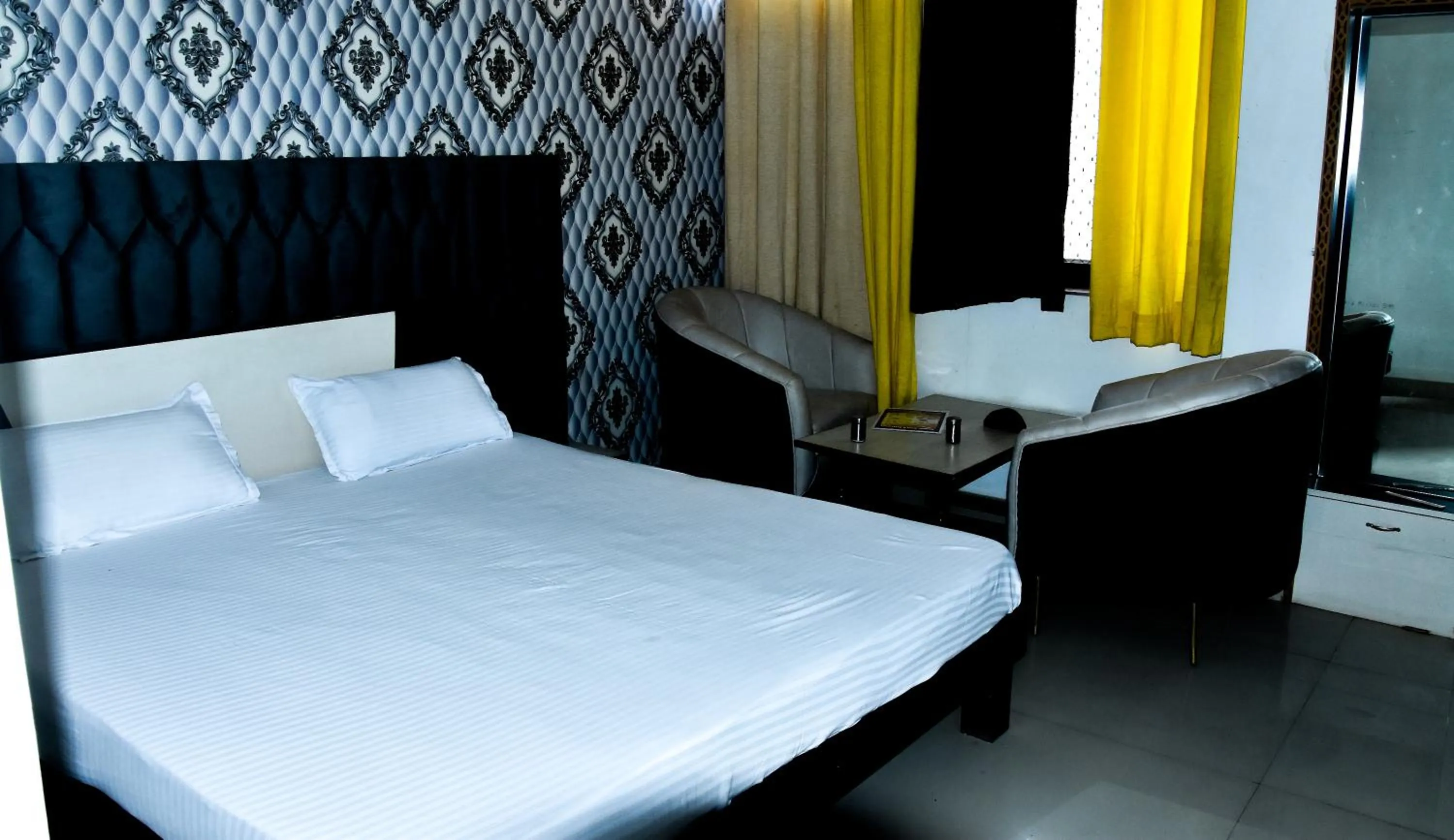 Seating area, Bed in Sangam Hotel