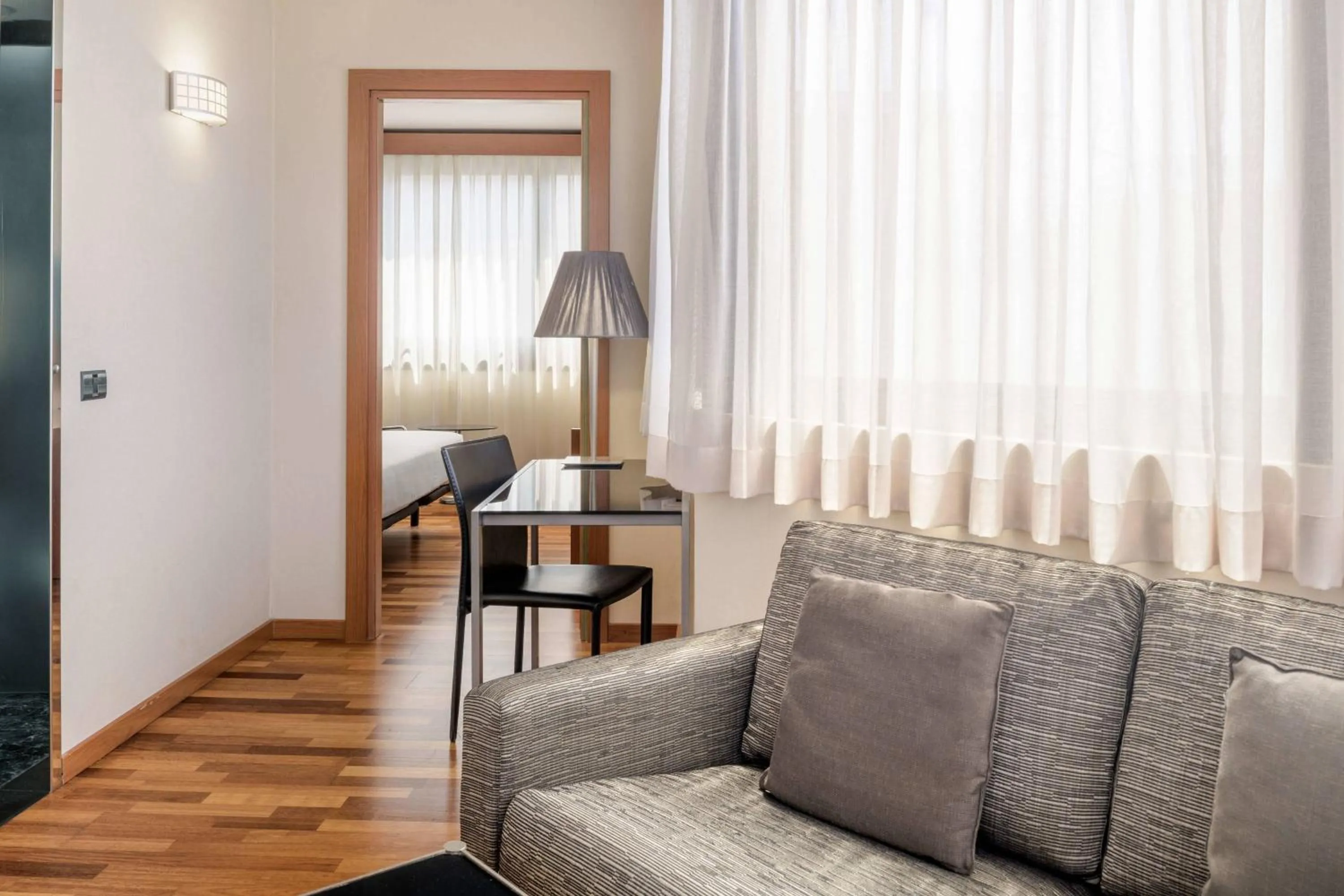 Living room in AC Hotel Genova by Marriott