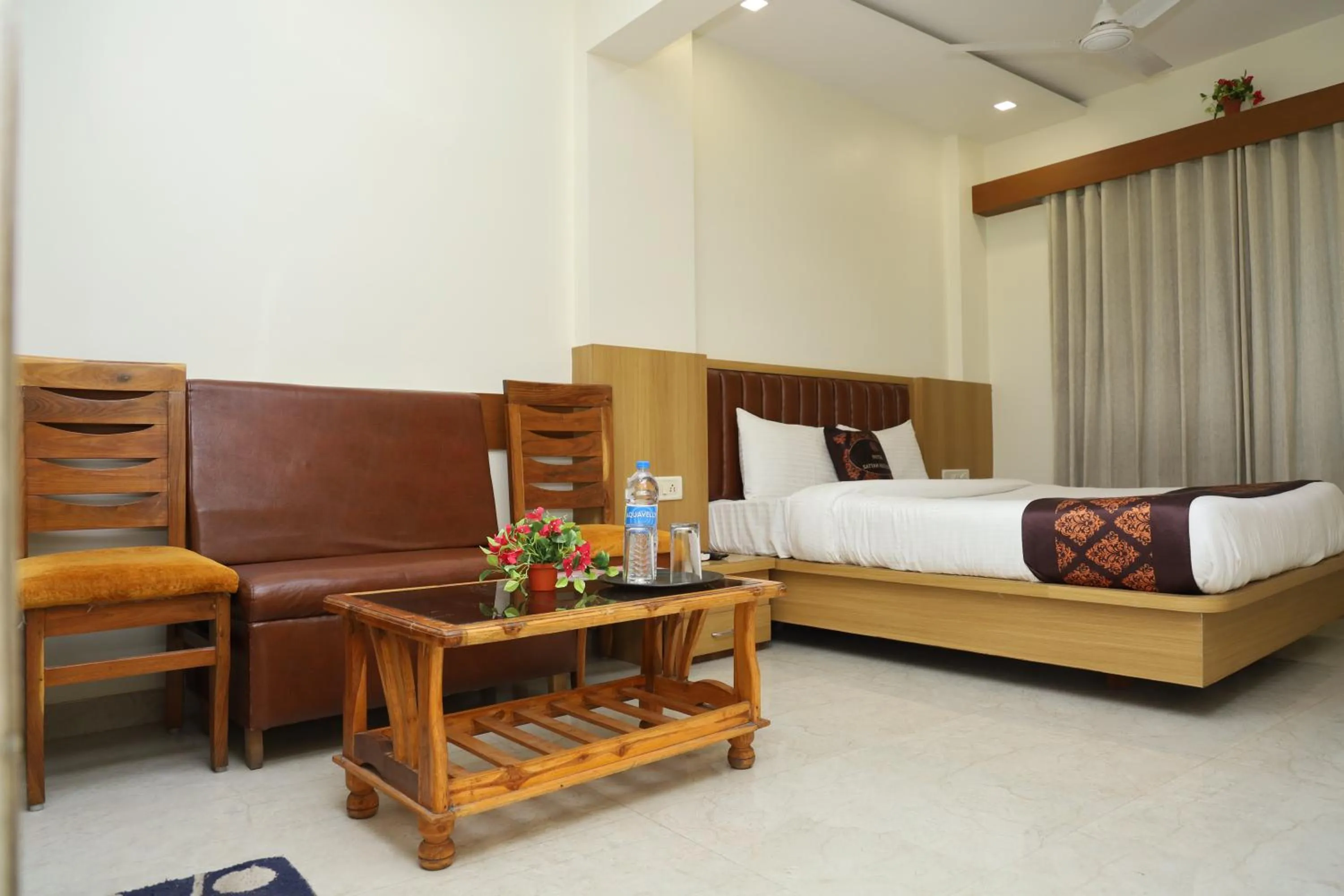 Seating area, Bed in Hotel Satyam Residency