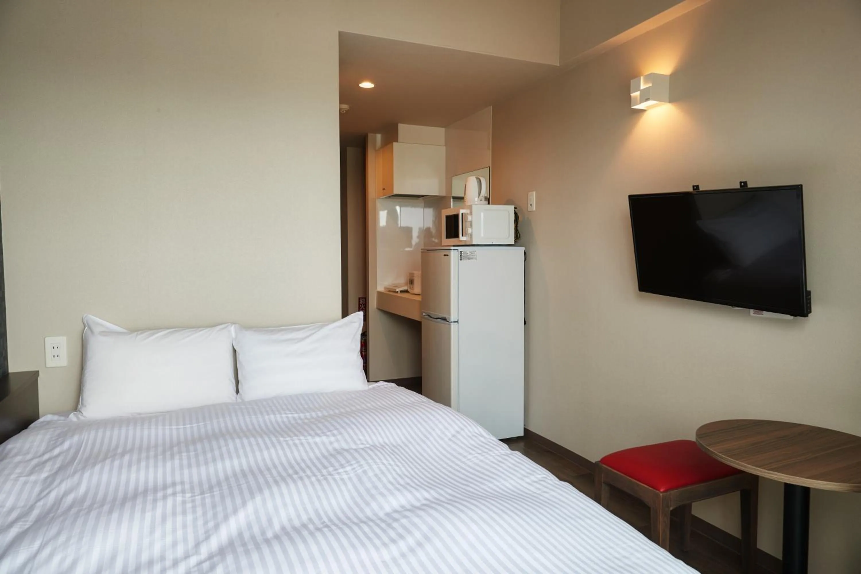 Bed in New Normal Condo in NAHA AIRPORT ニューノーマルコンドイン那覇エアポート