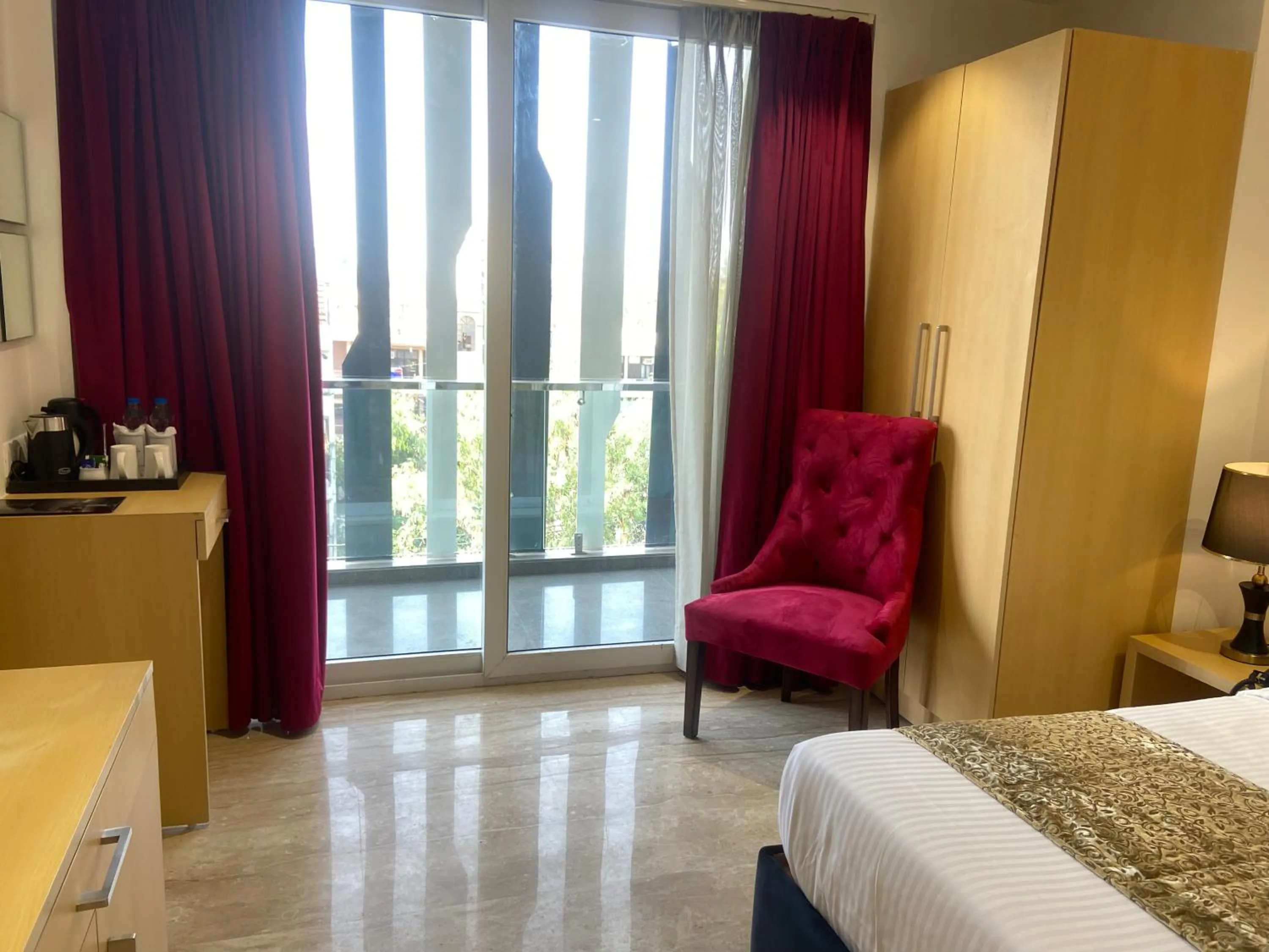 Seating area, Bed in Hotel Malbork Inn Rajouri Garden Delhi - Couple Friendly Local IDs Accepted