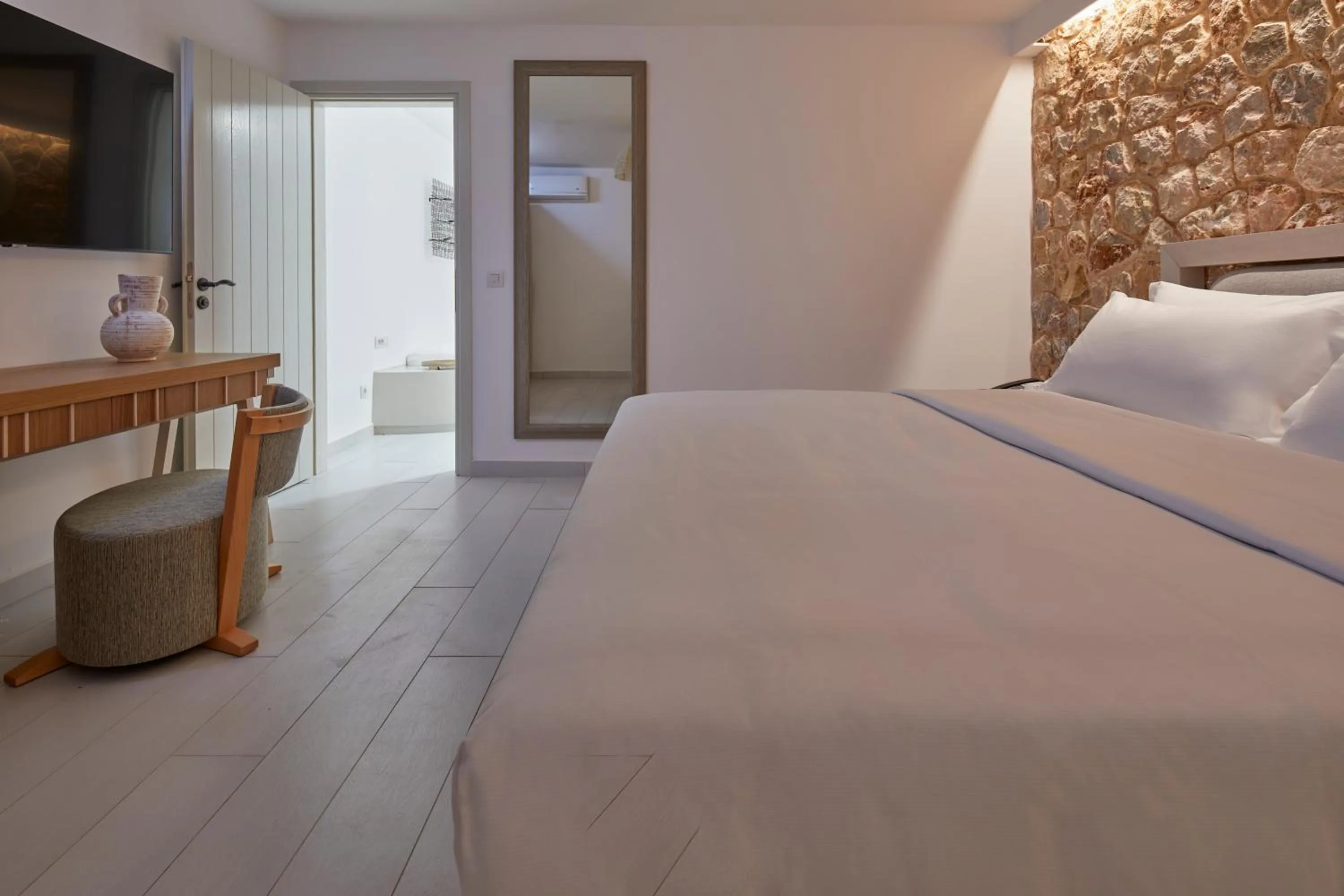 Bed in Sea Breeze Santorini Beach Resort, Curio By Hilton