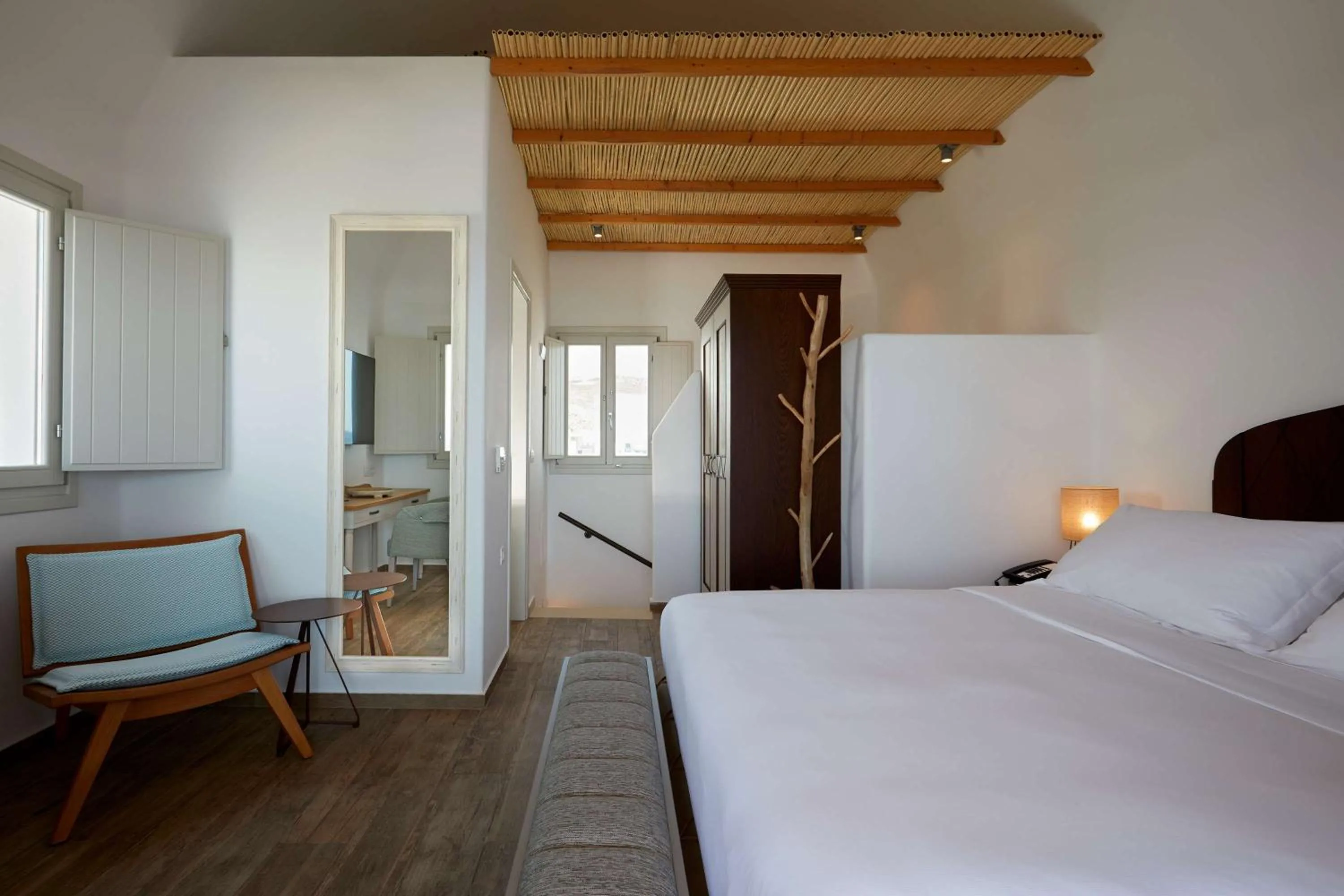 Bed in Sea Breeze Santorini Beach Resort, Curio By Hilton