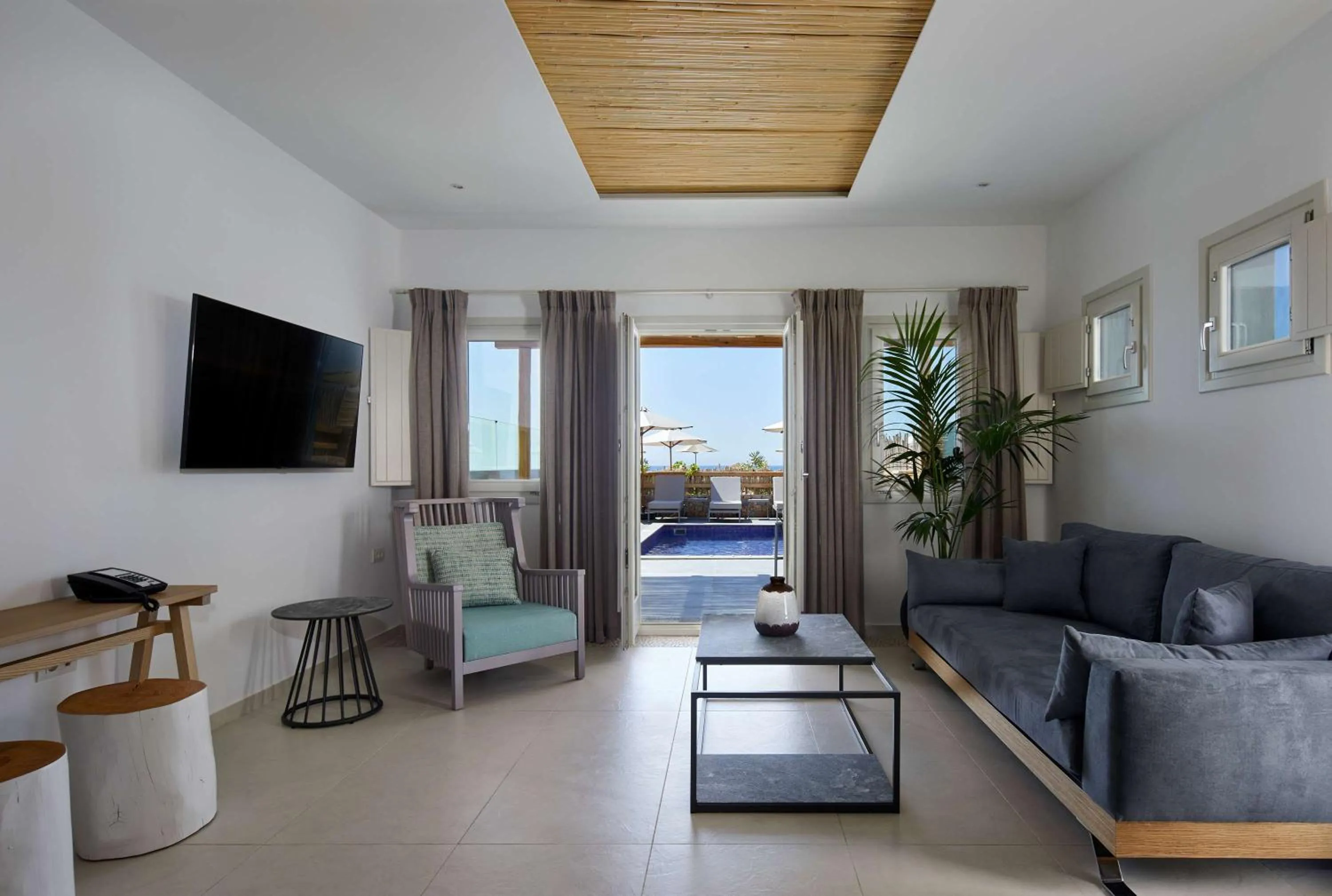 Living room in Sea Breeze Santorini Beach Resort, Curio By Hilton