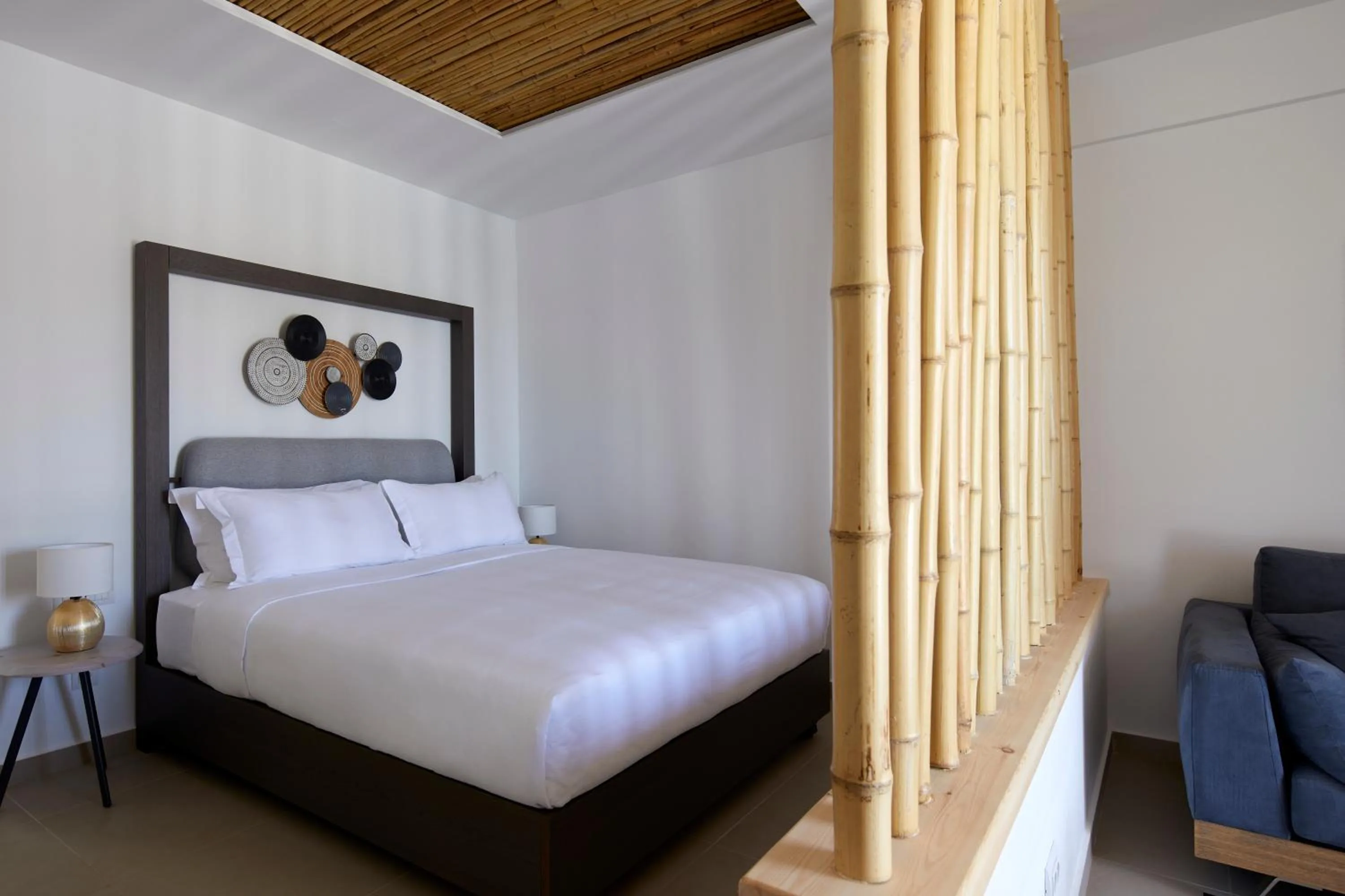 Bed in Sea Breeze Santorini Beach Resort, Curio By Hilton