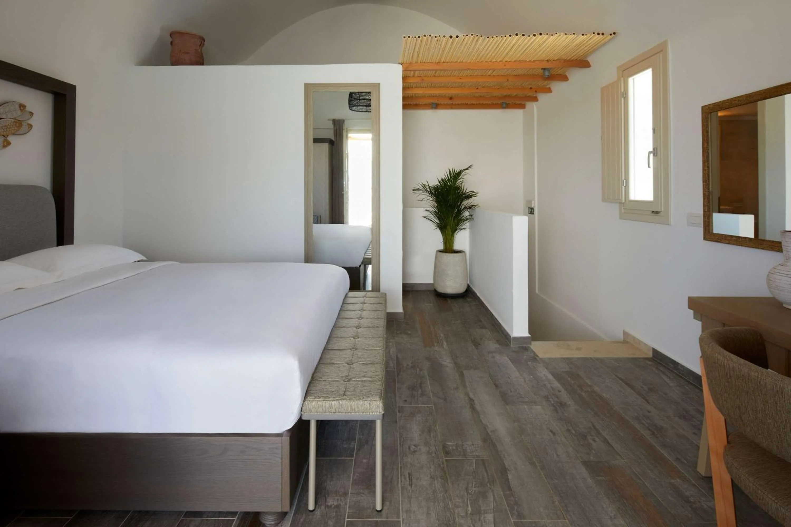 Bed in Sea Breeze Santorini Beach Resort, Curio By Hilton