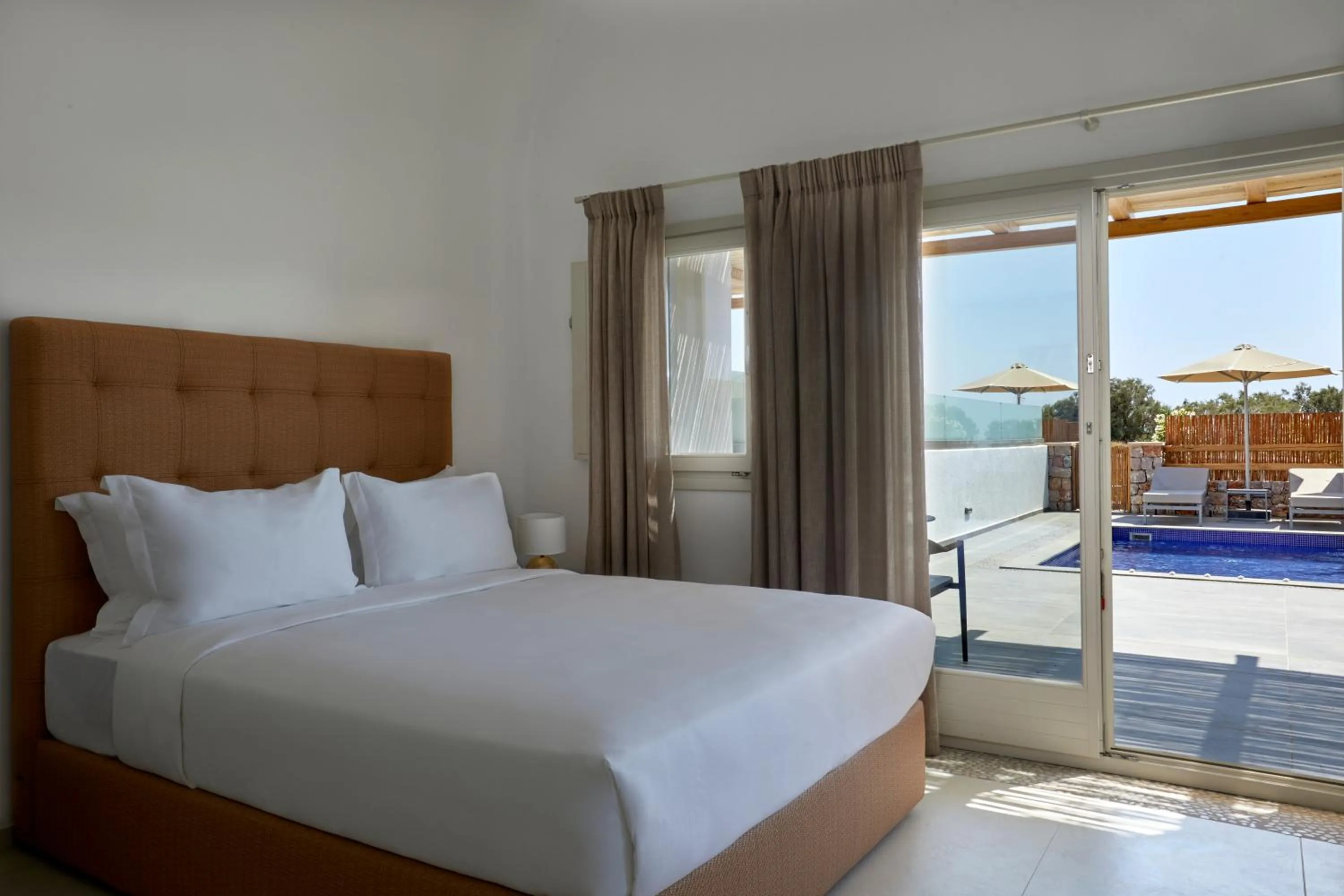 Bed in Sea Breeze Santorini Beach Resort, Curio By Hilton