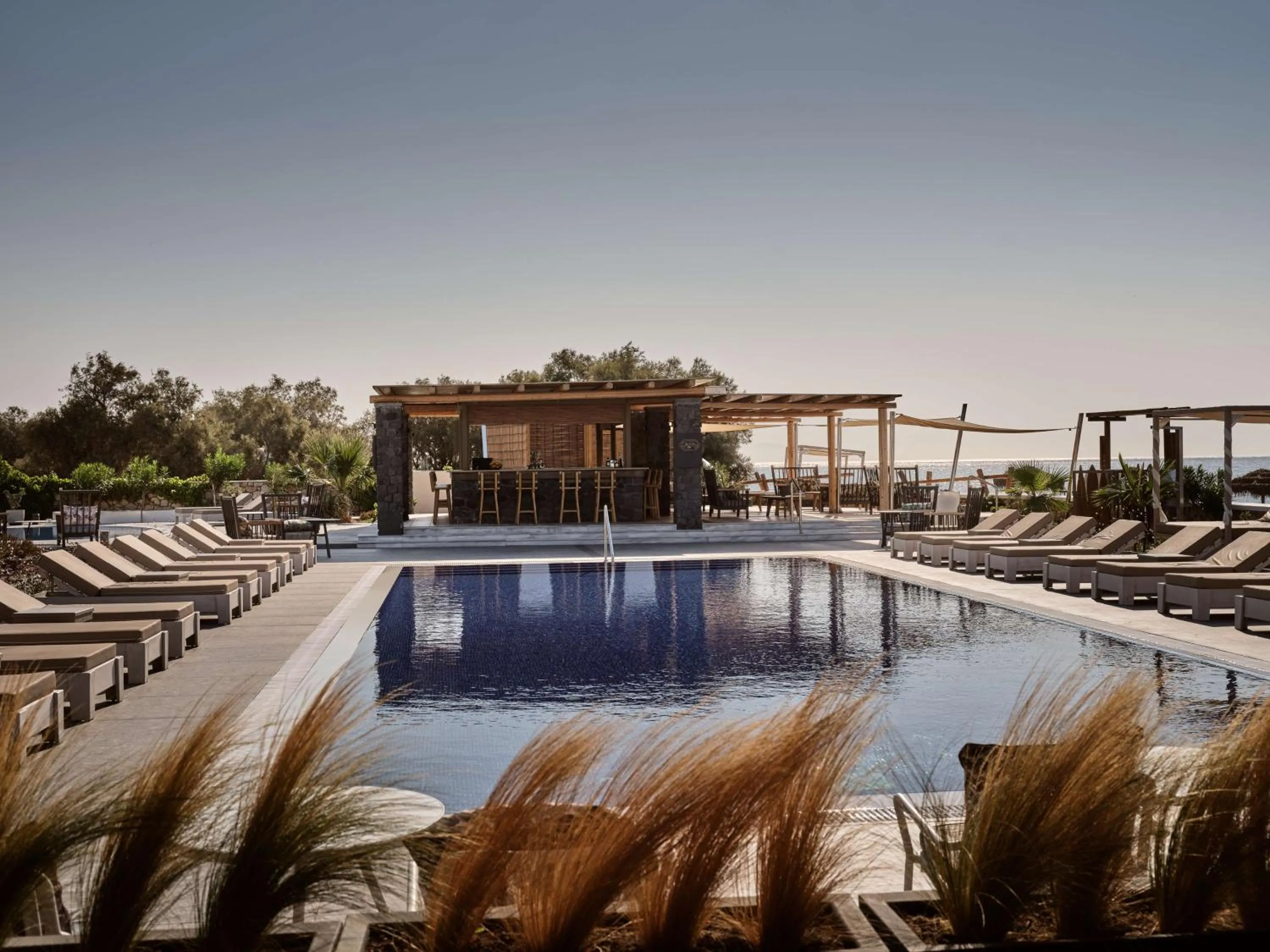 Pool view in Sea Breeze Santorini Beach Resort, Curio By Hilton