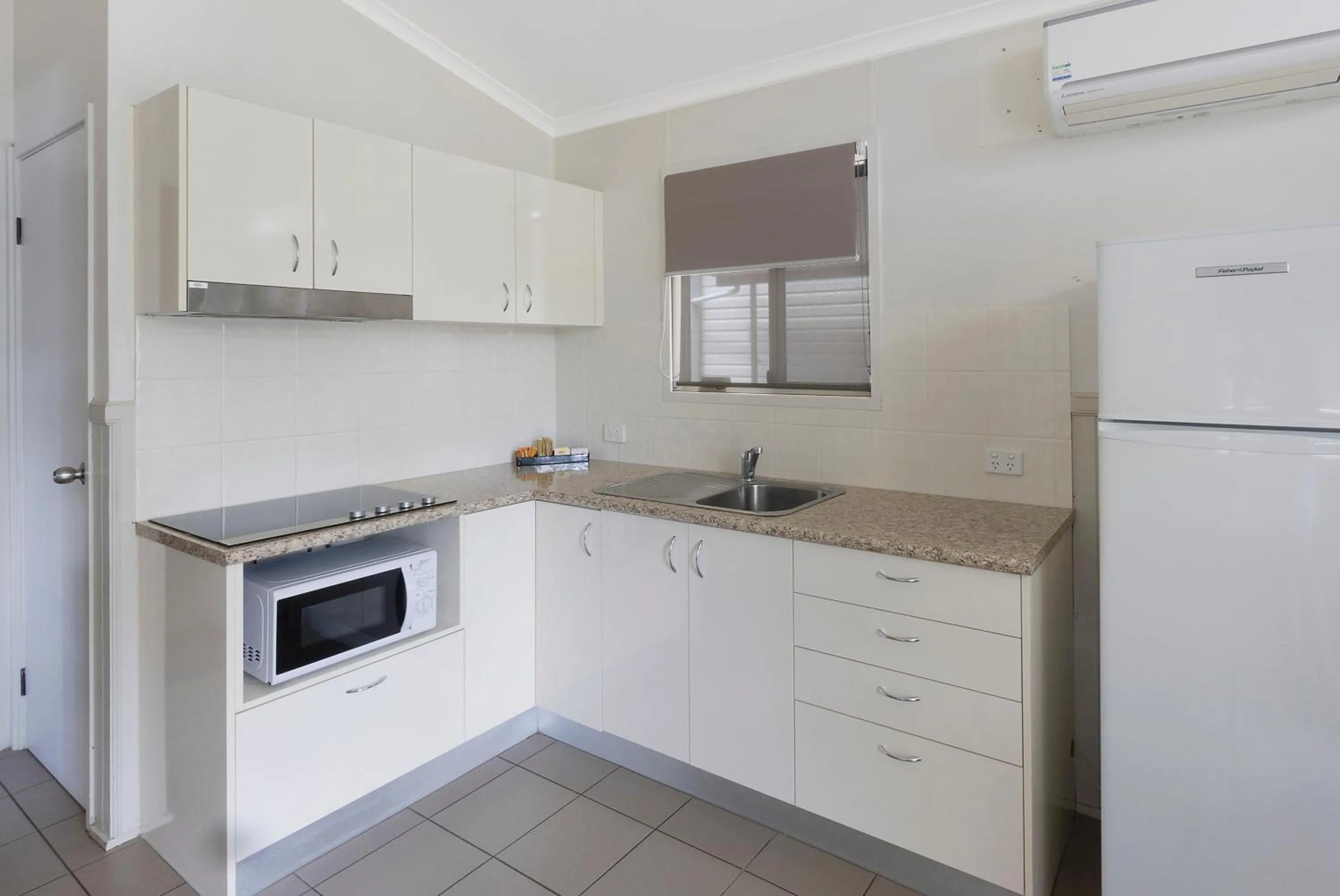 Kitchen or kitchenette in Reflections Tuncurry - Holiday Park