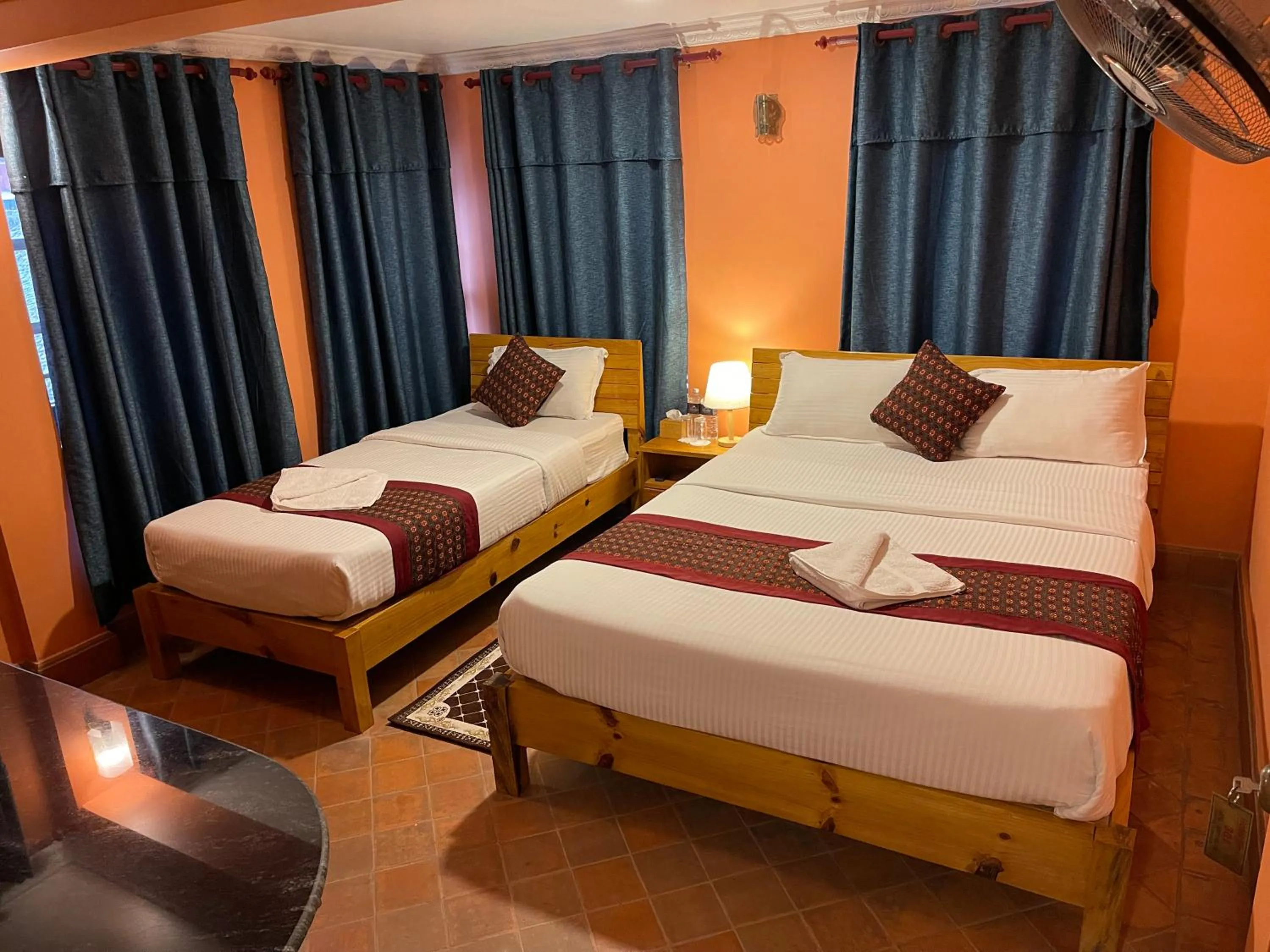 Bed in Hotel Empire & Rooftop Restaurant