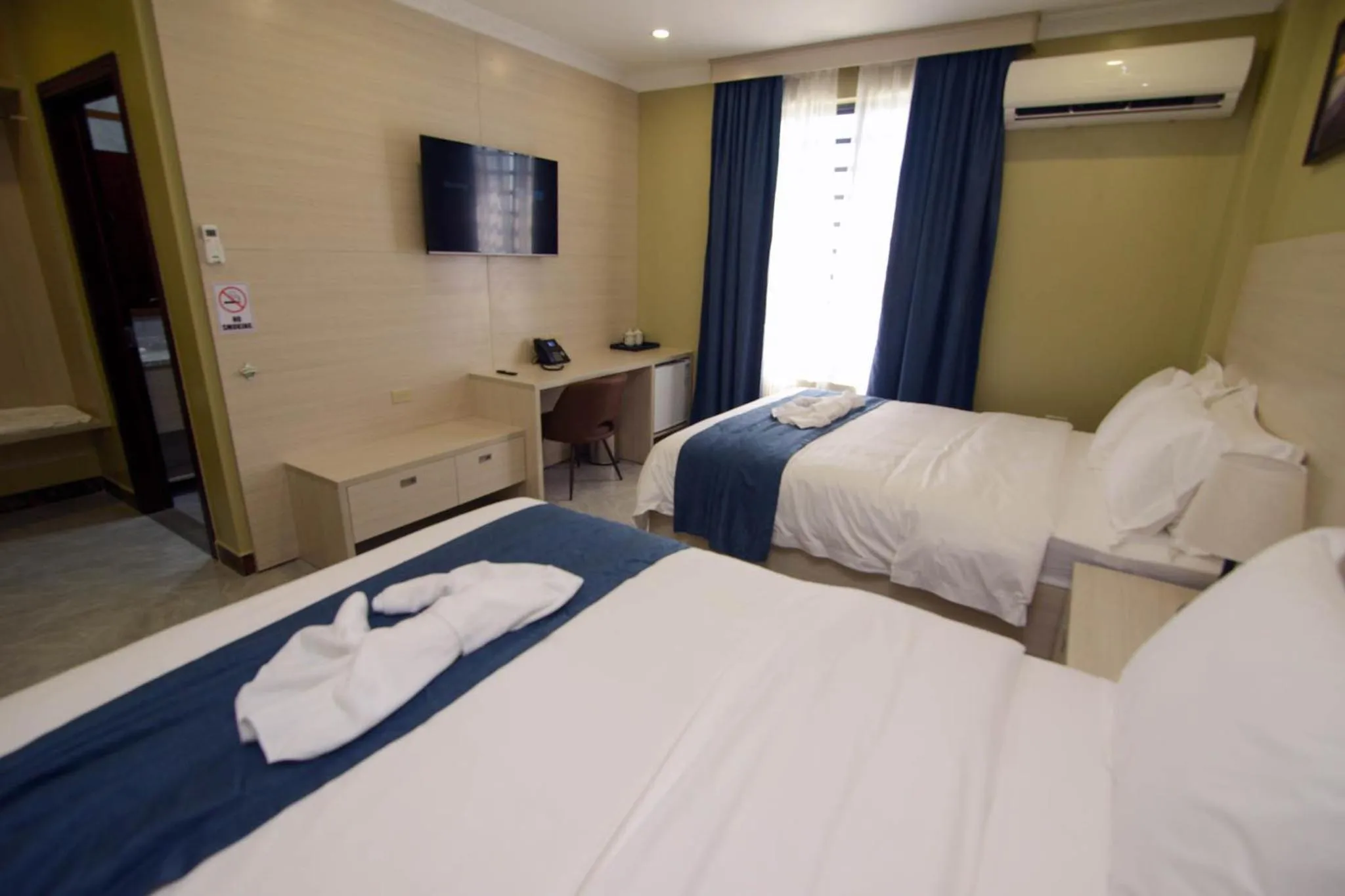 Photo of the whole room, Bed in The Caye Hotel Caye Caulker