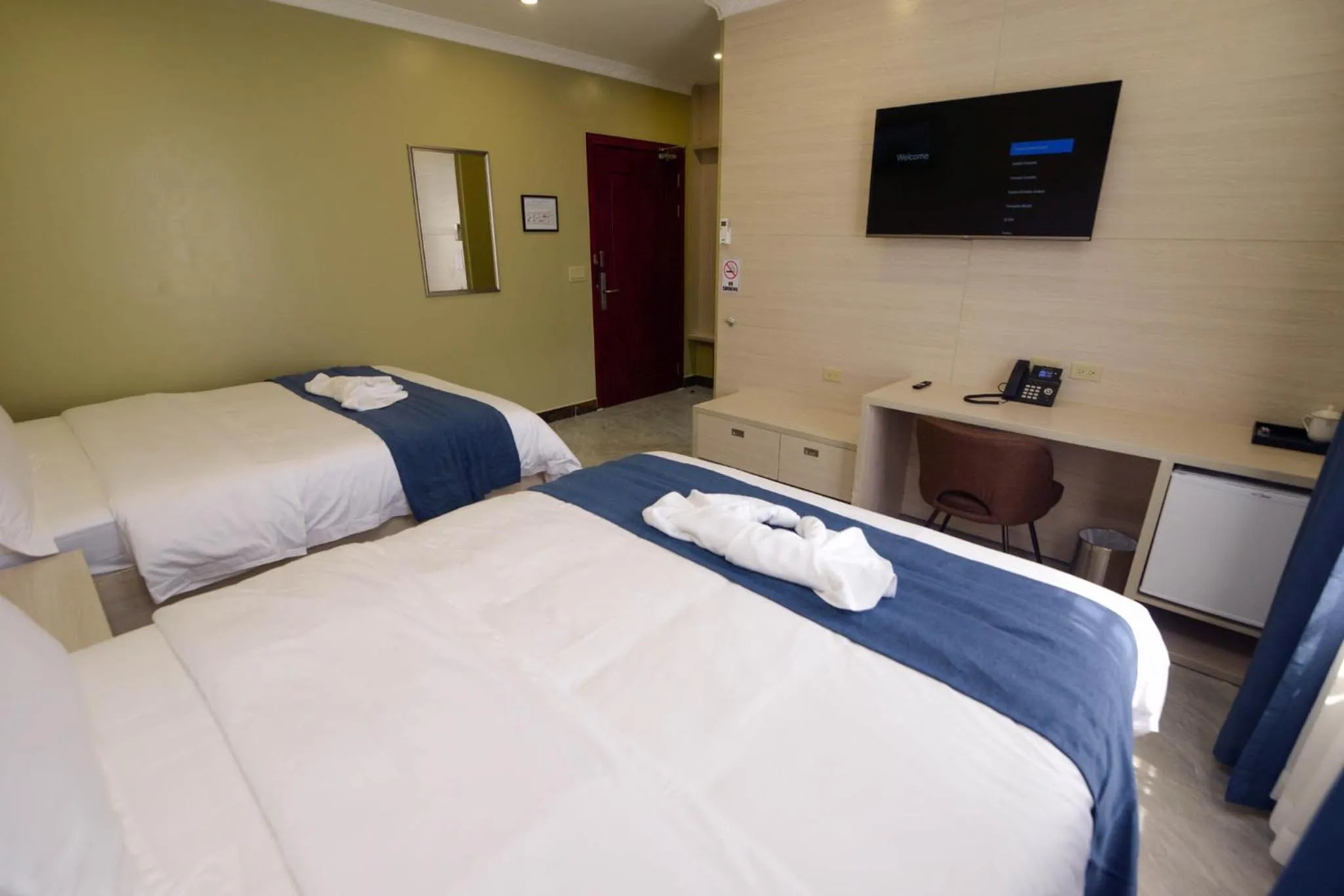 Photo of the whole room, Bed in The Caye Hotel Caye Caulker