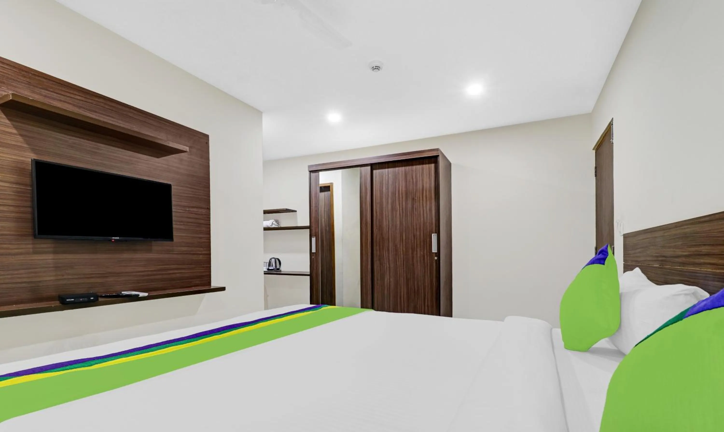 Bedroom, Bed in Treebo Purple Orchid Boutique