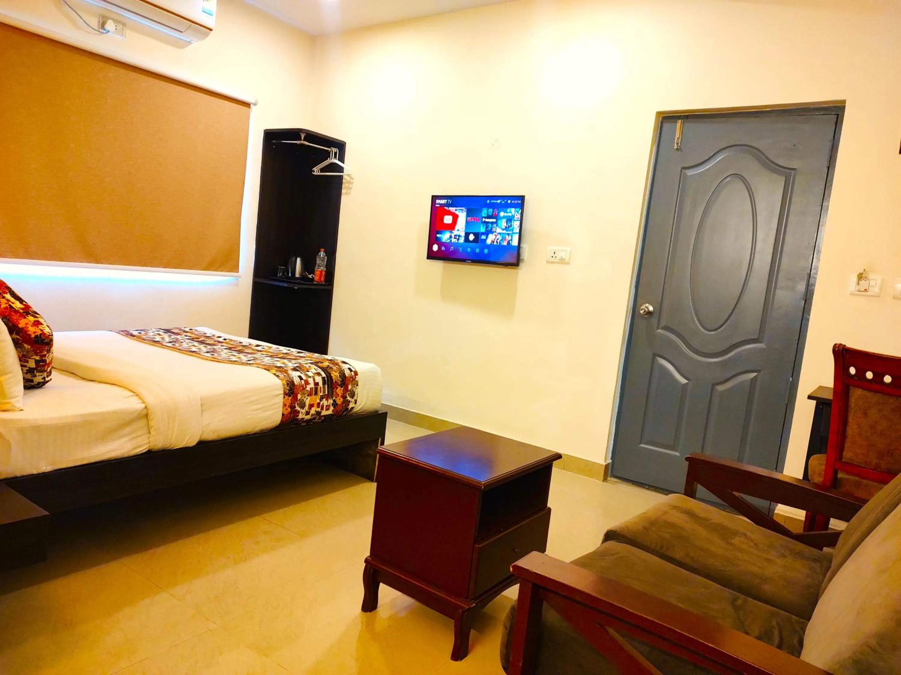 Communal lounge/ TV room in Athasri Hotel HSR Layout