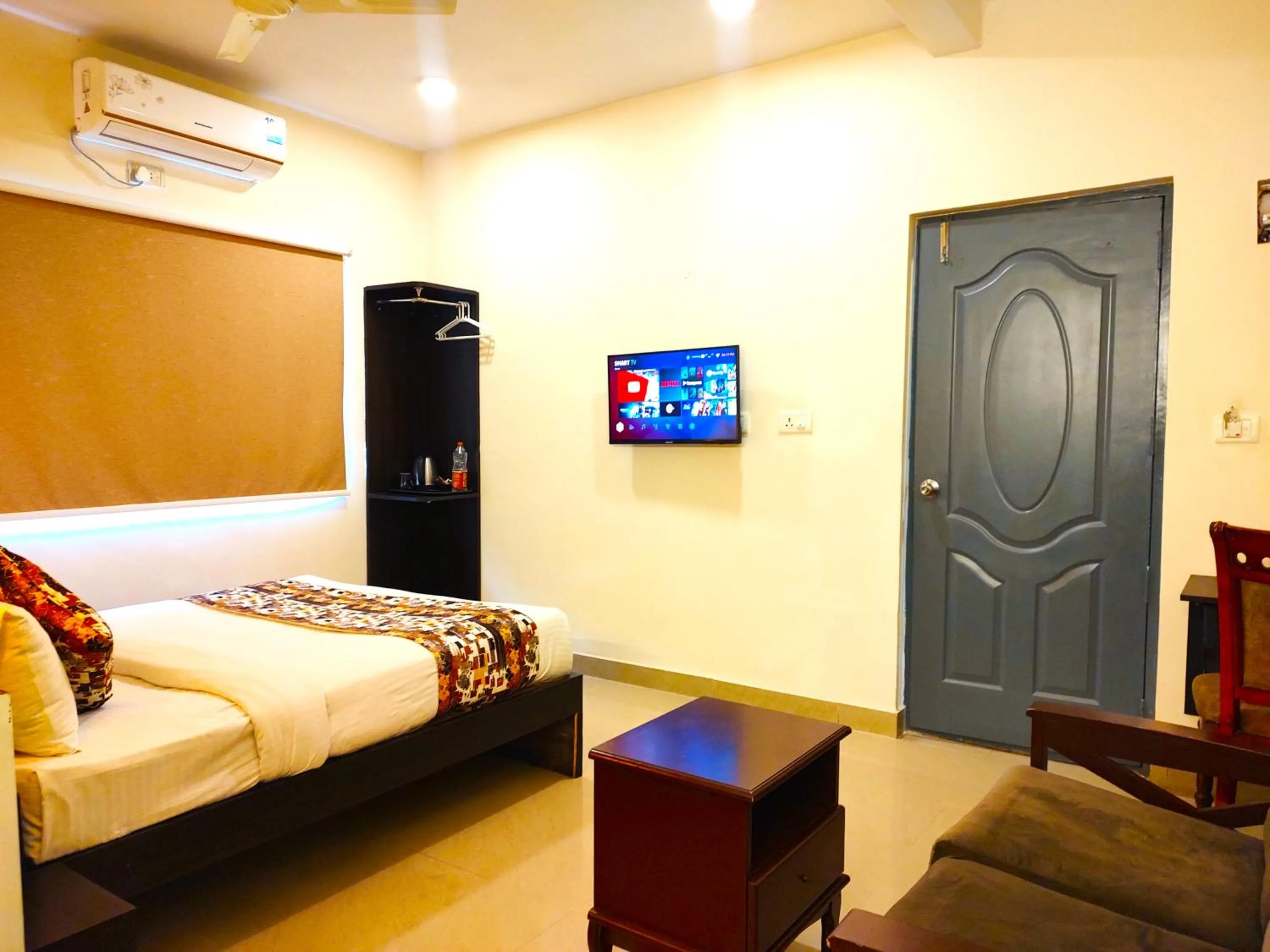 Communal lounge/ TV room in Athasri Hotel HSR Layout