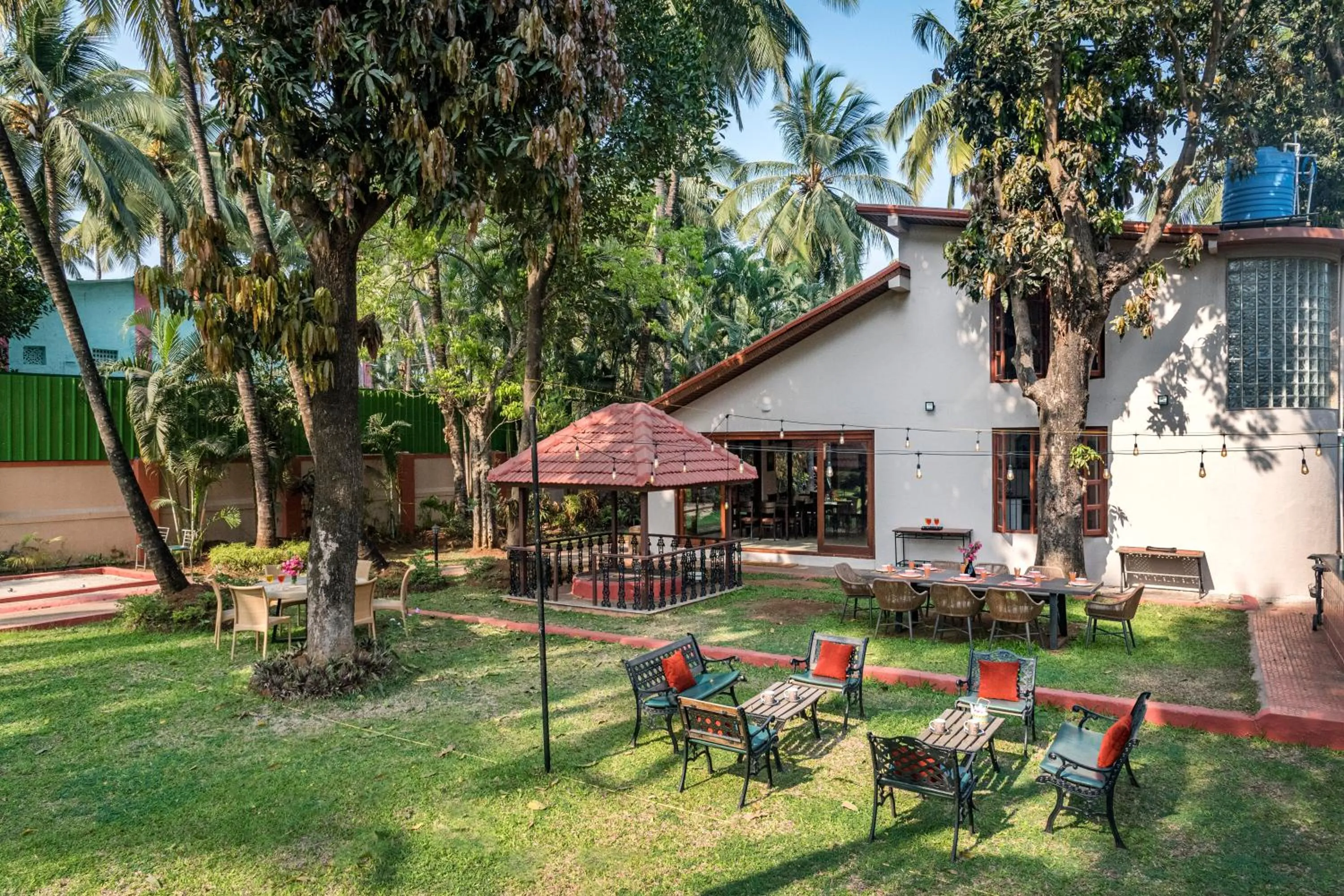 Property building in SaffronStays Casa Del Palms - 8BR luxury pool villa with gazebo, pickleball, bar & lawns near Nagaon Beach