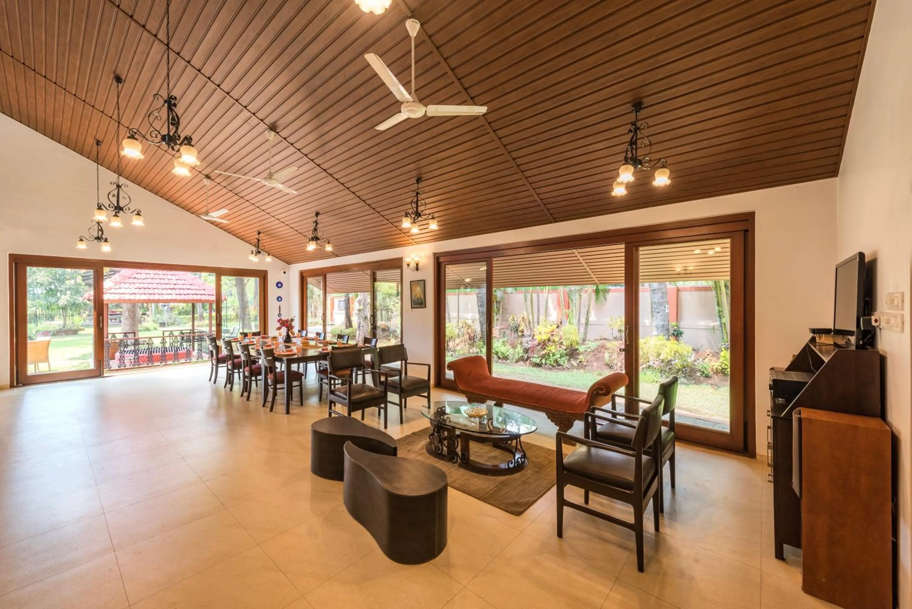 TV and multimedia in SaffronStays Casa Del Palms - 8BR luxury pool villa with gazebo, pickleball, bar & lawns near Nagaon Beach