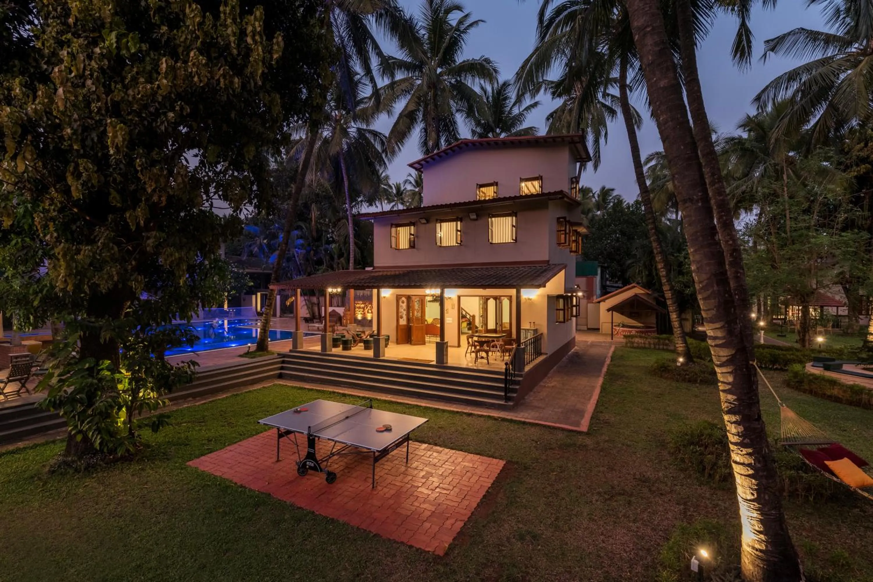 Property building in SaffronStays Casa Del Palms - 8BR luxury pool villa with gazebo, pickleball, bar & lawns near Nagaon Beach