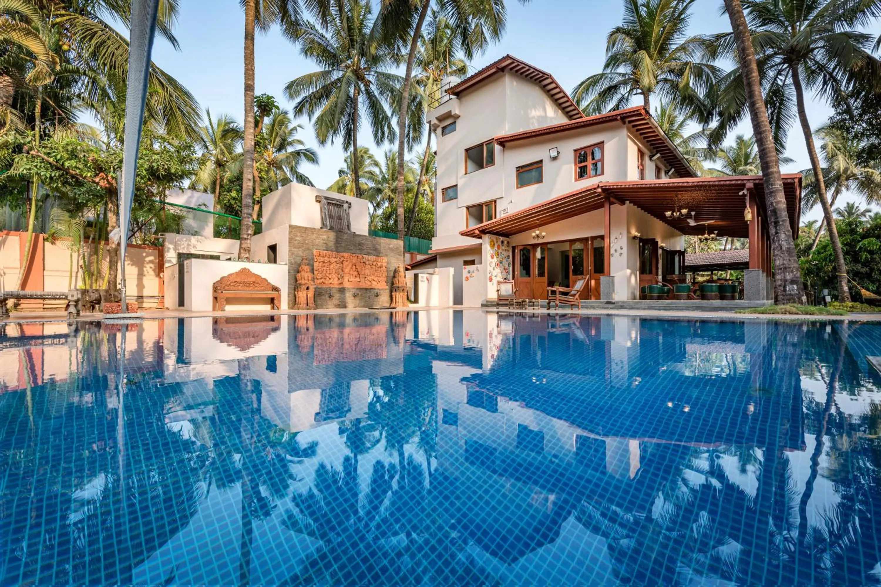Property building in SaffronStays Casa Del Palms - 8BR luxury pool villa with gazebo, pickleball, bar & lawns near Nagaon Beach