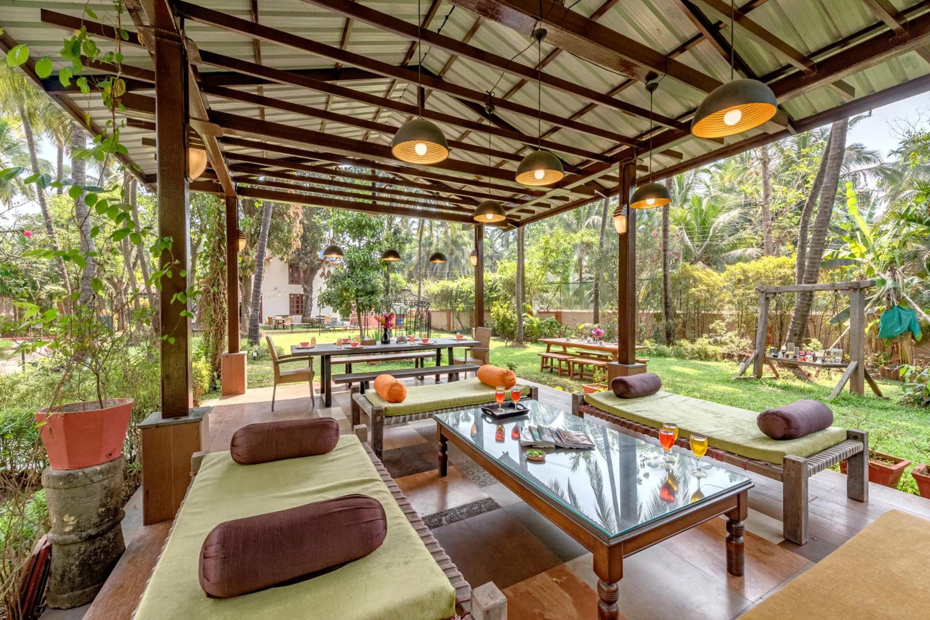 Day in SaffronStays Casa Del Palms - 8BR luxury pool villa with gazebo, pickleball, bar & lawns near Nagaon Beach