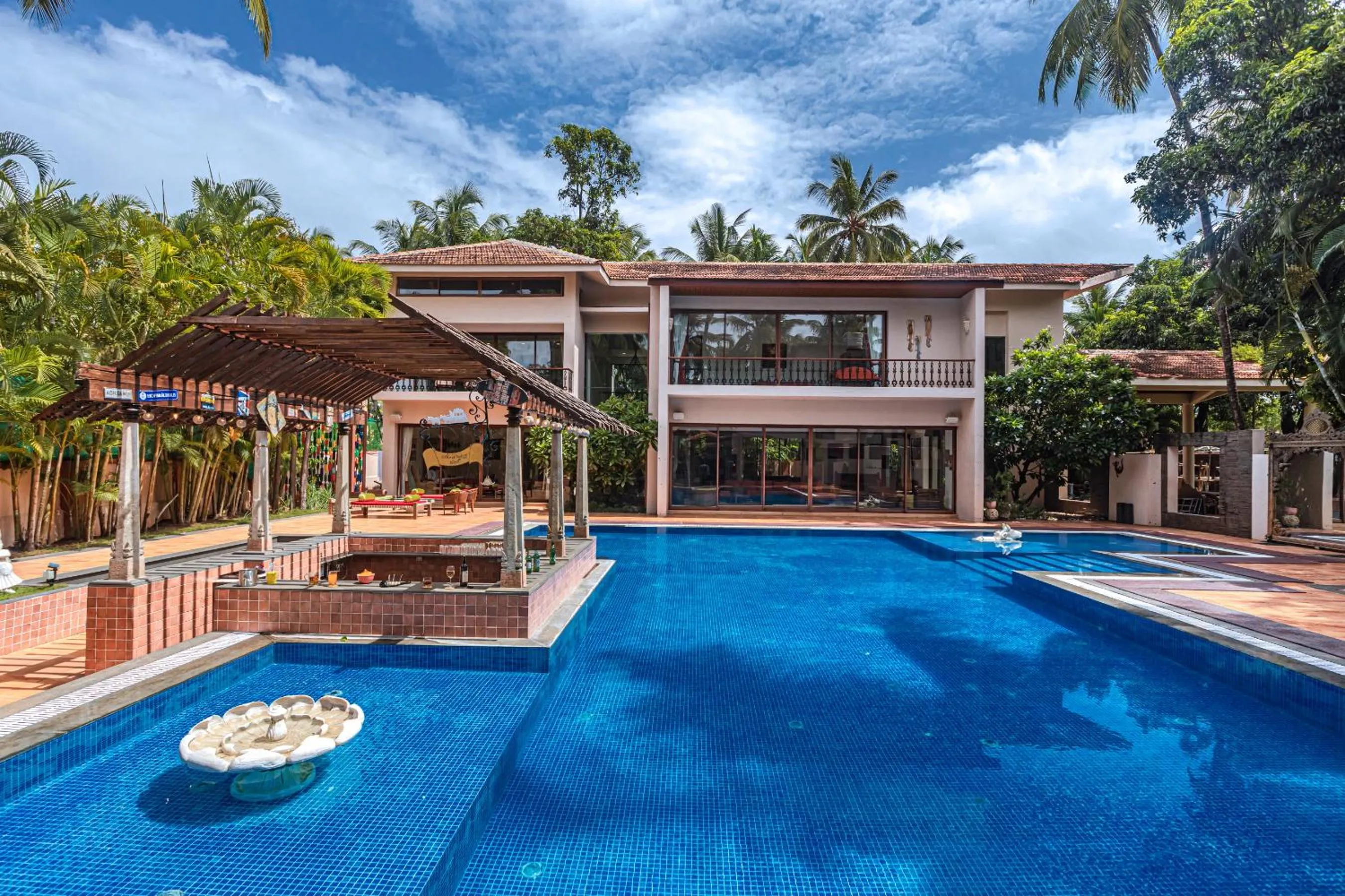 Property building in SaffronStays Casa Del Palms - 8BR luxury pool villa with gazebo, pickleball, bar & lawns near Nagaon Beach