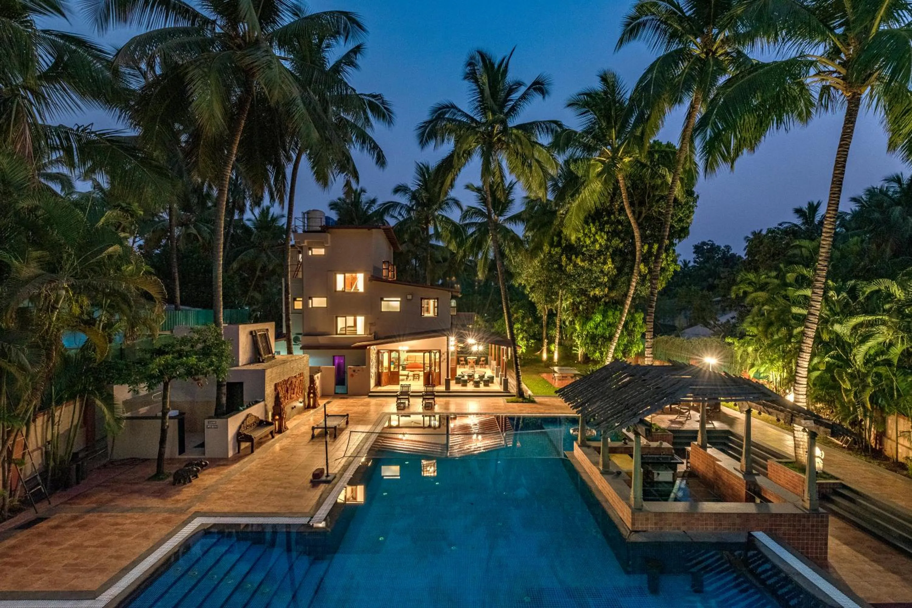 Property building in SaffronStays Casa Del Palms - 8BR luxury pool villa with gazebo, pickleball, bar & lawns near Nagaon Beach