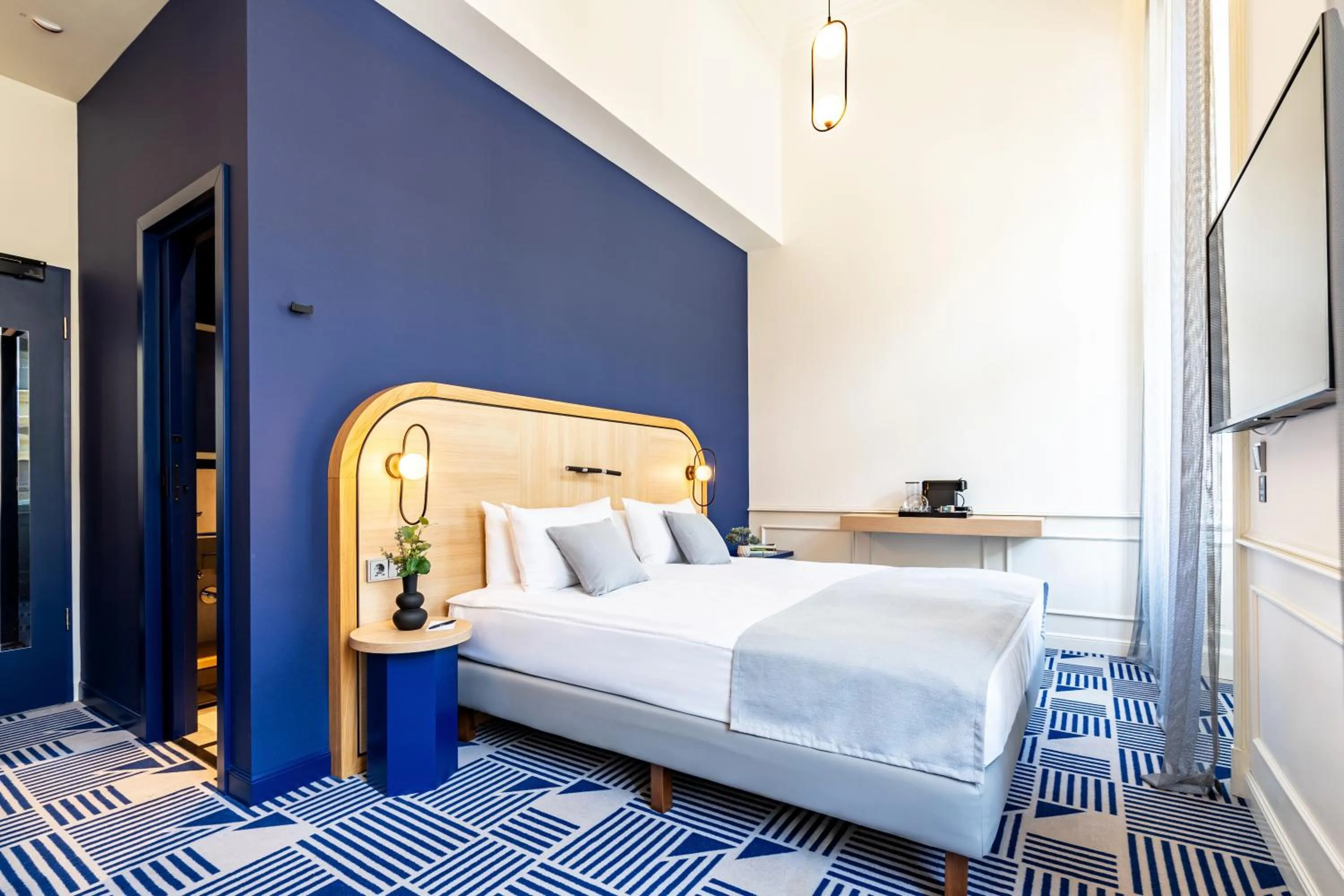 Bed in Hotel Oktogon Haggenmacher by Continental Group