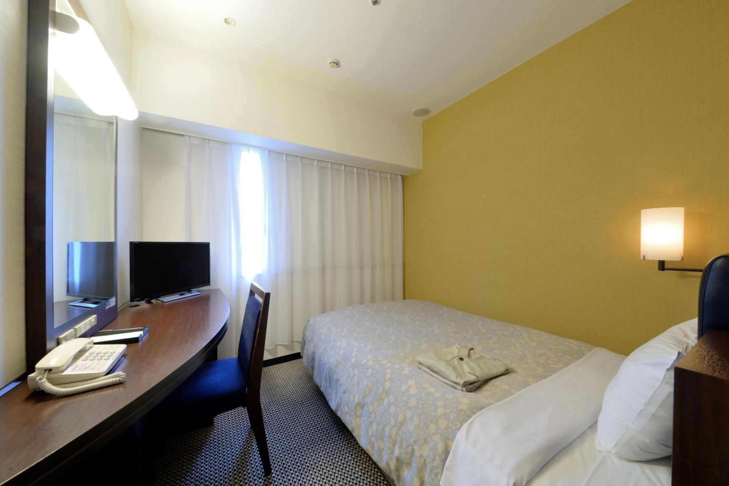 Photo of the whole room, Bed in Takaoka Manten Hotel Ekimae