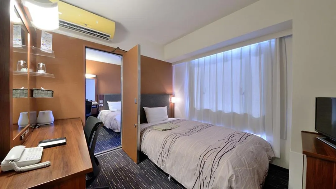 Bed in Tsuruga Manten Hotel Ekimae