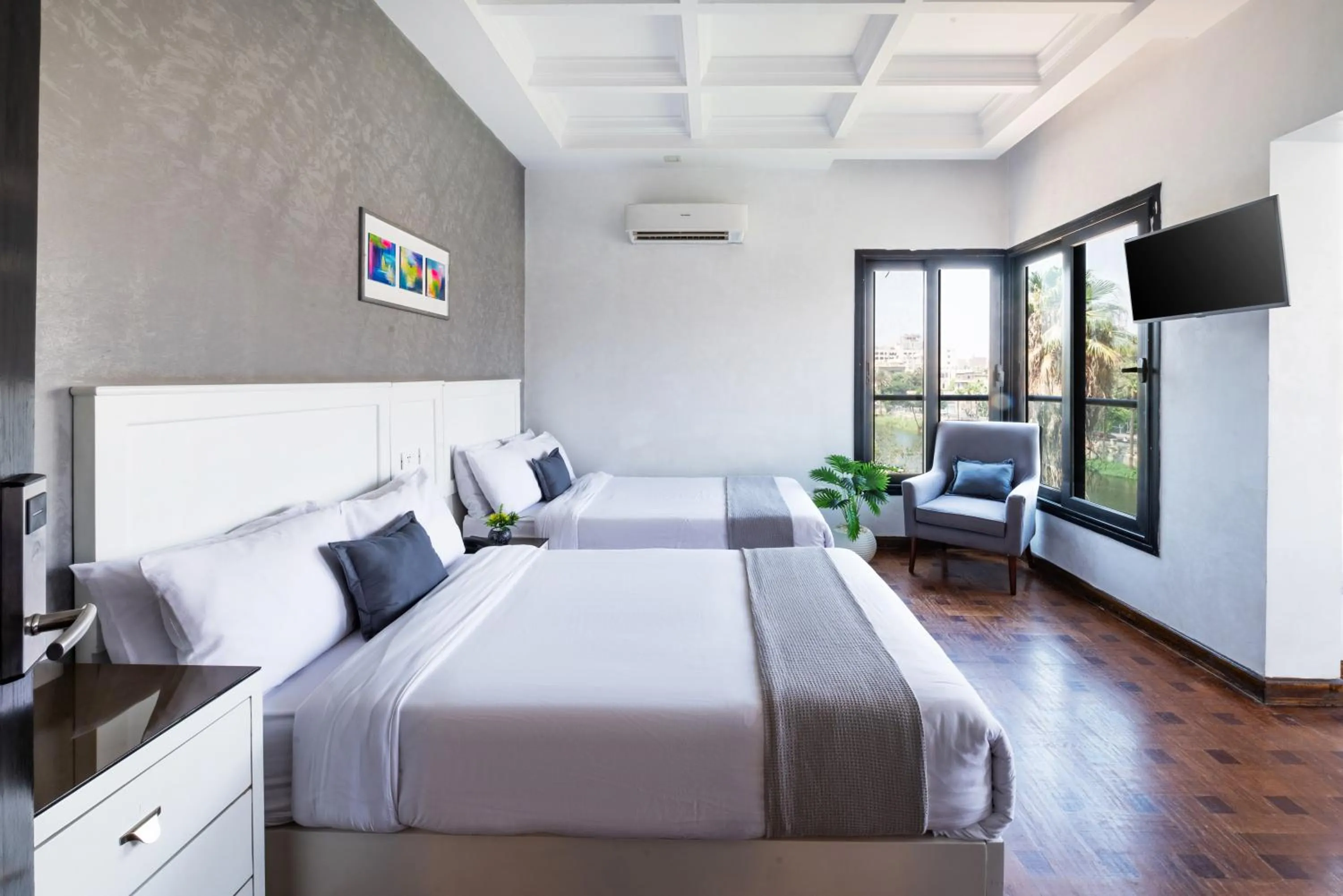 Communal lounge/ TV room, Bed in Nile Villa Hotel