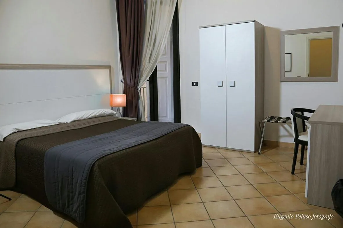 Bed in Caravaggio Hotel