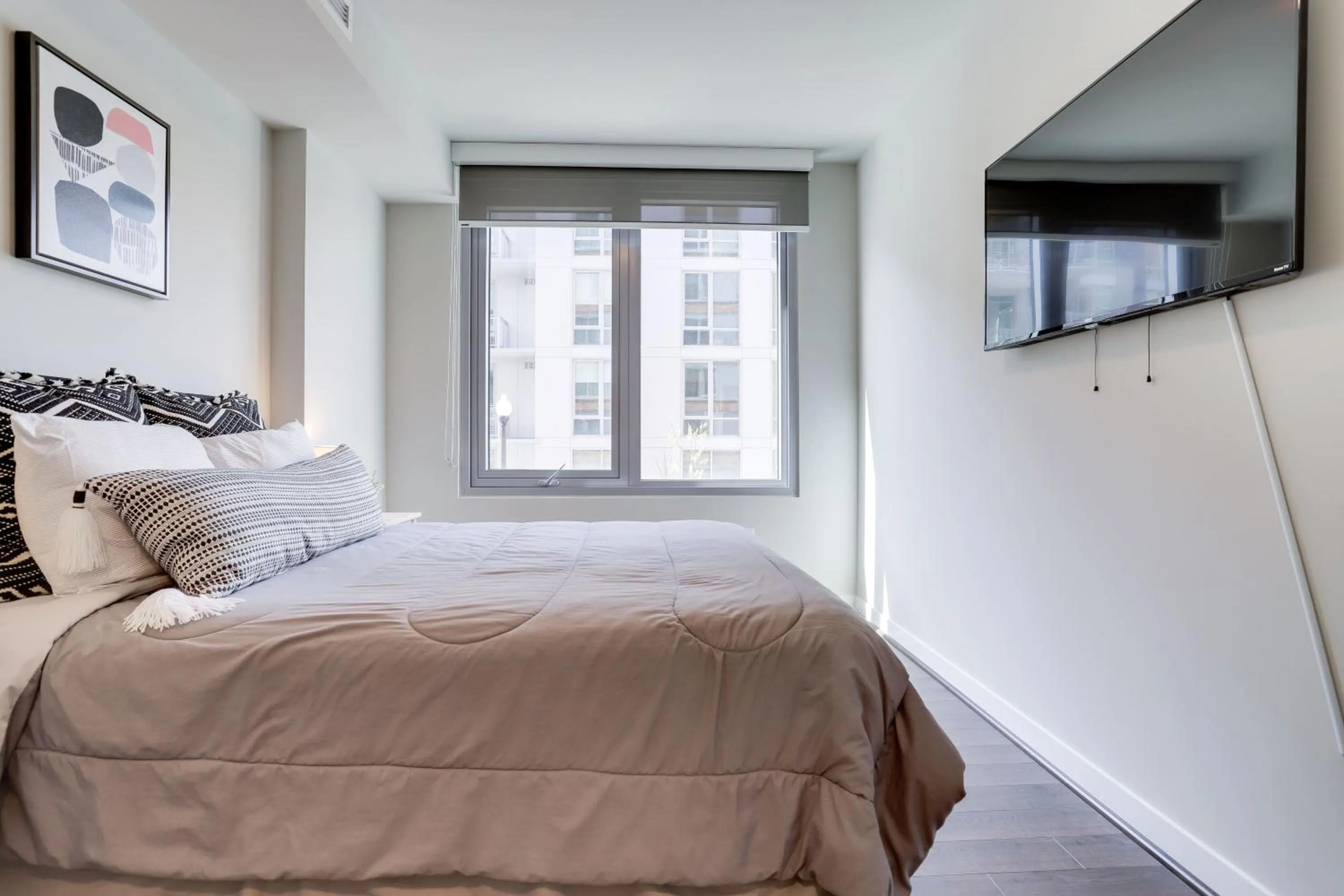 Bed in Stylish Condo at Clarendon with Rooftop Views