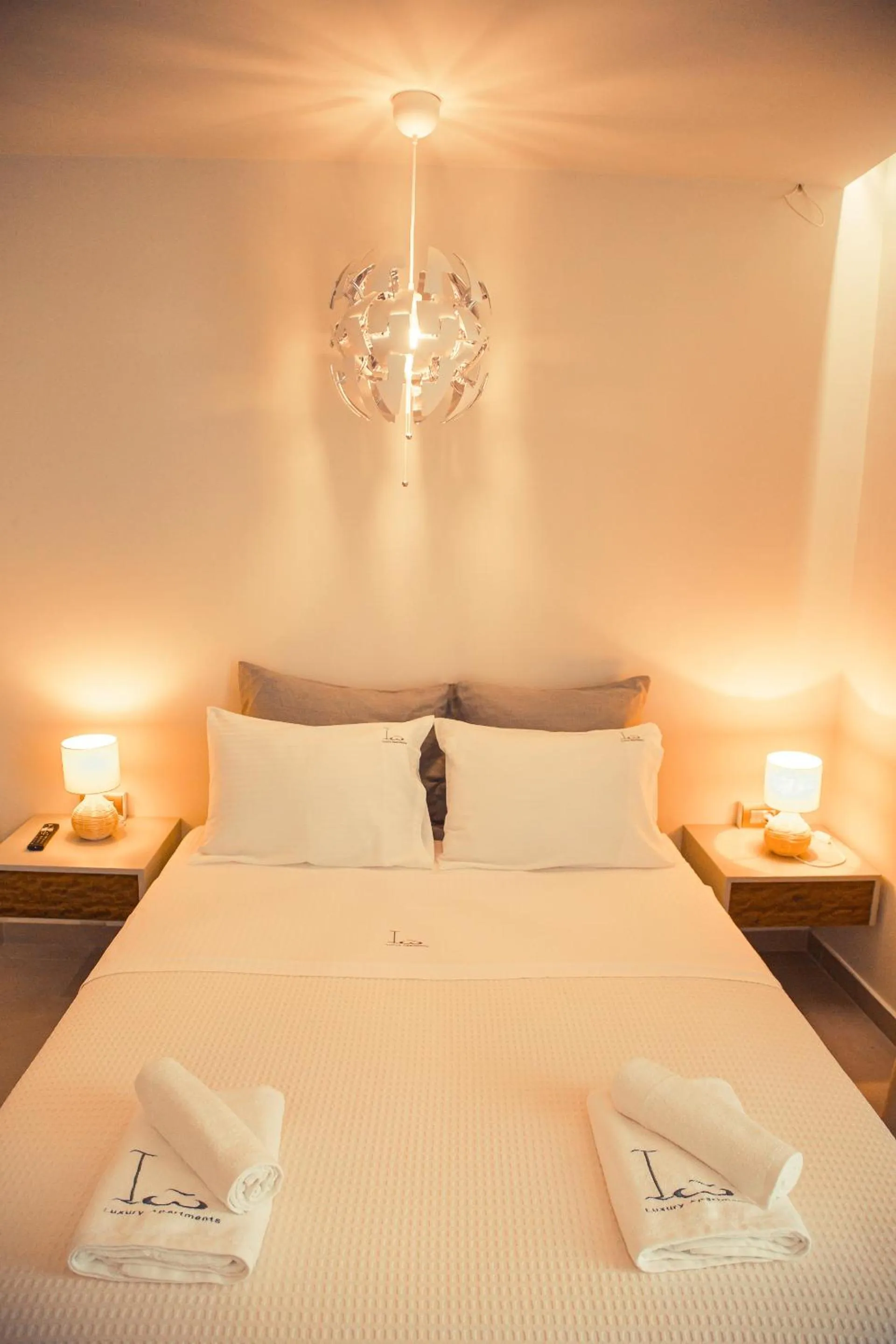 Bed in IO Luxury Pool & Hot Tub Suites