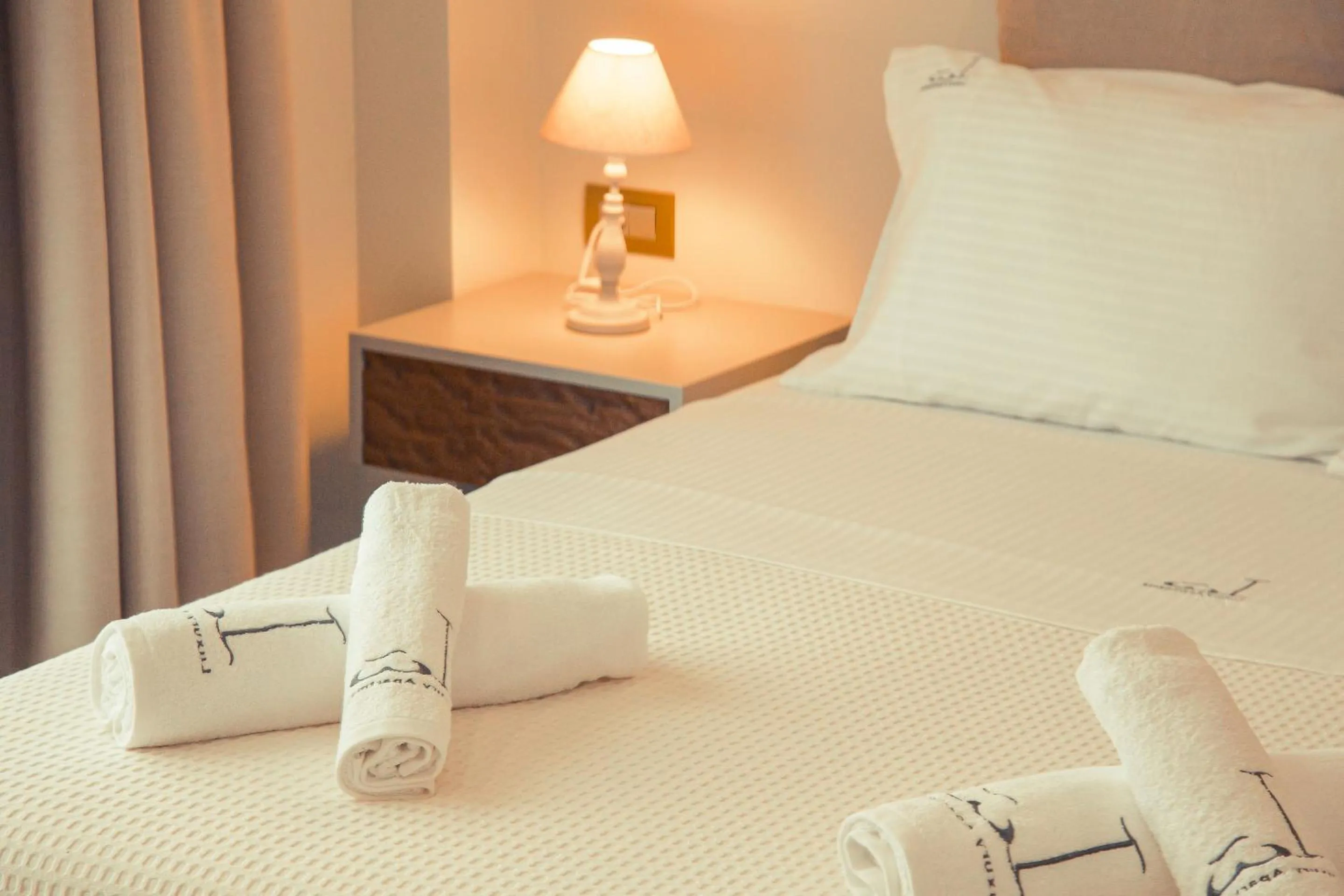 Bed in IO Luxury Pool & Hot Tub Suites