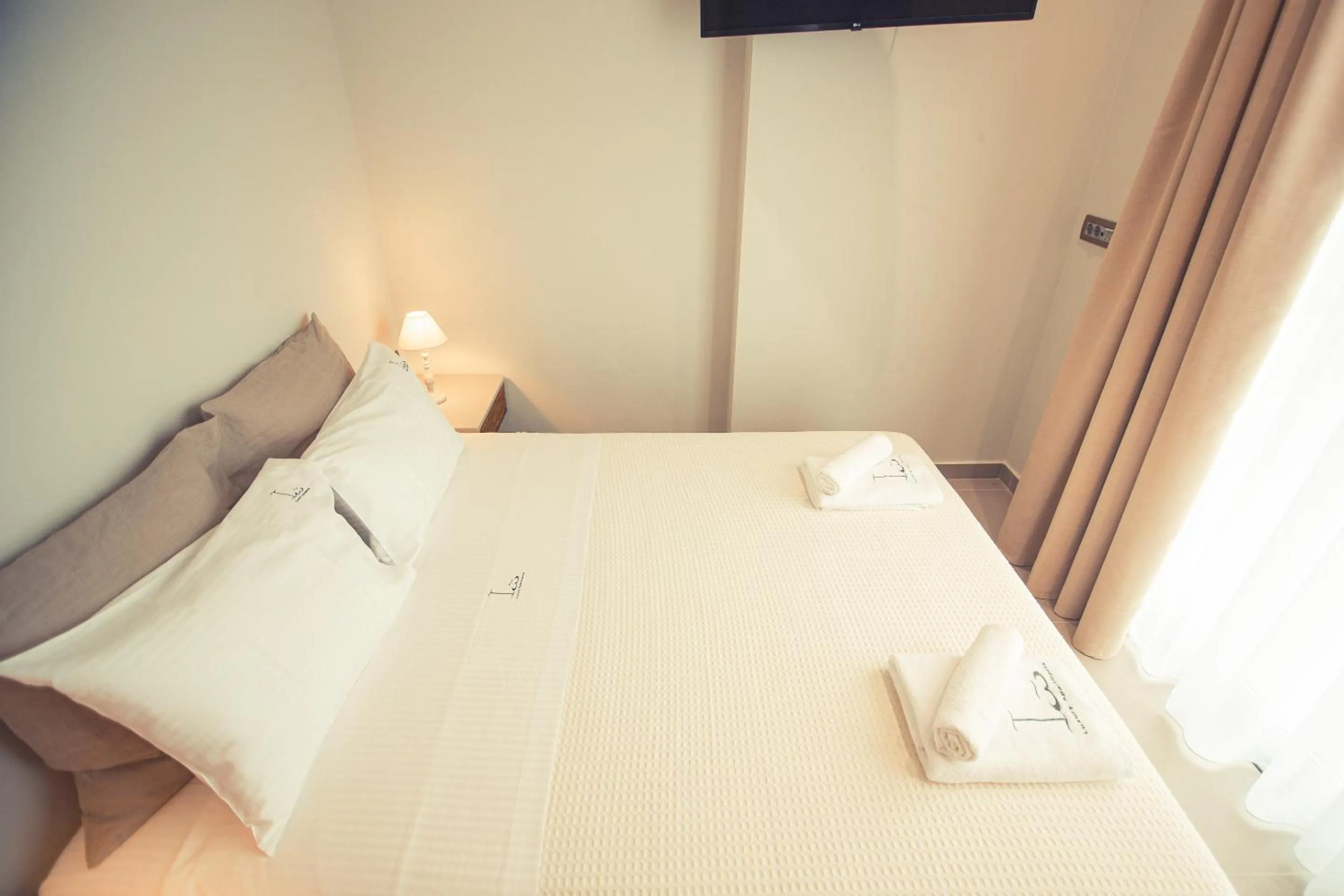 Bed in IO Luxury Pool & Hot Tub Suites