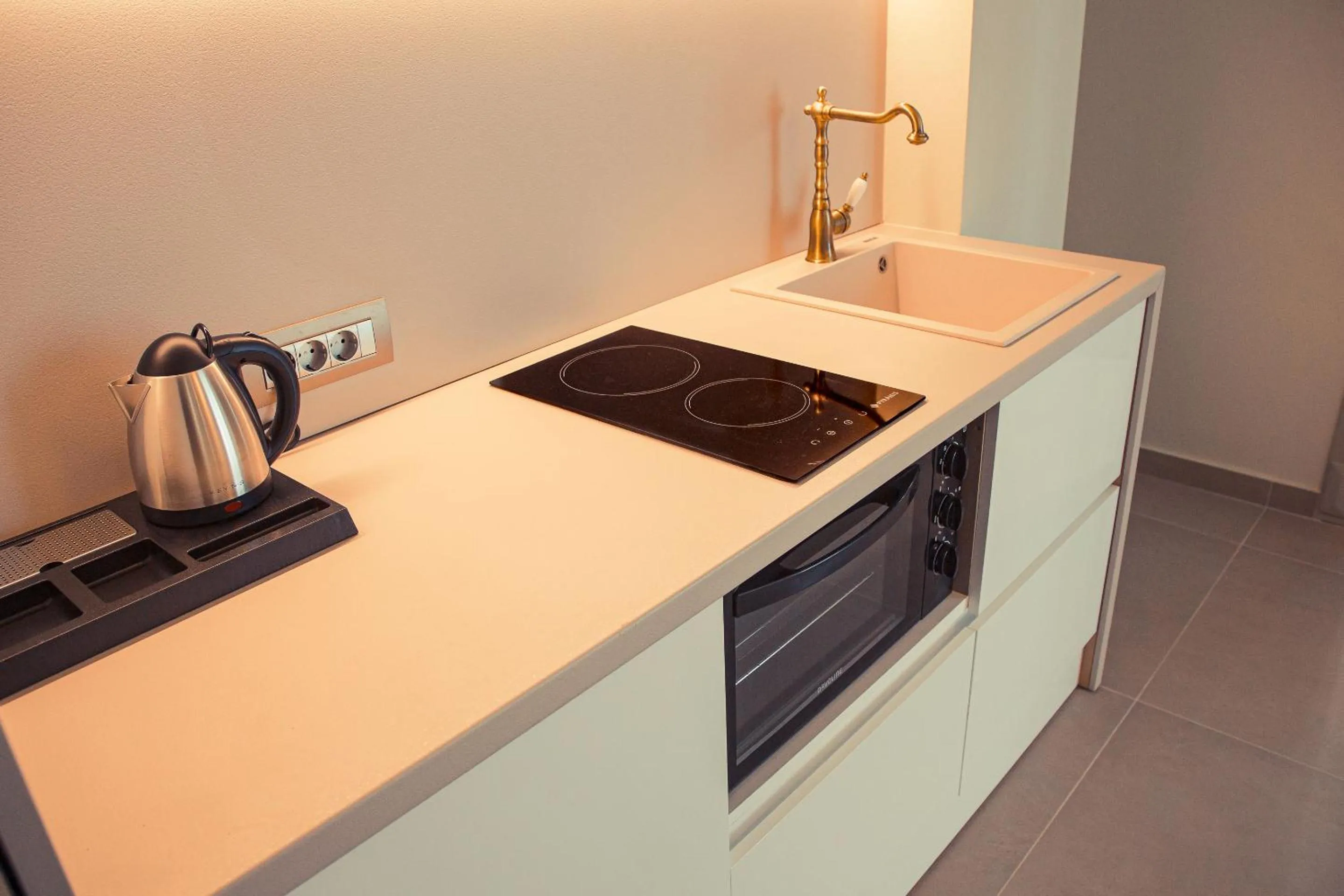 Kitchen or kitchenette in IO Luxury Pool & Hot Tub Suites