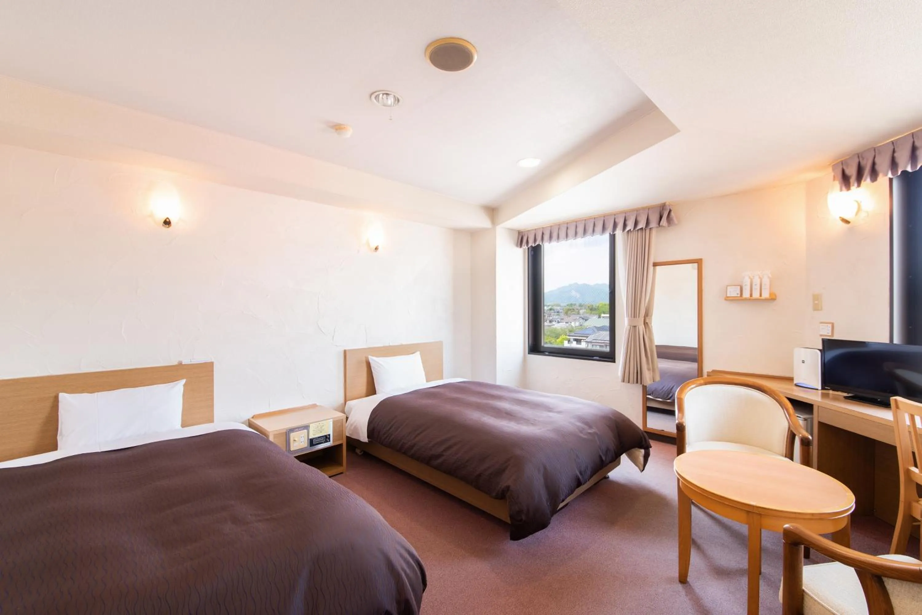 Bed in Hotel Primrose Saito