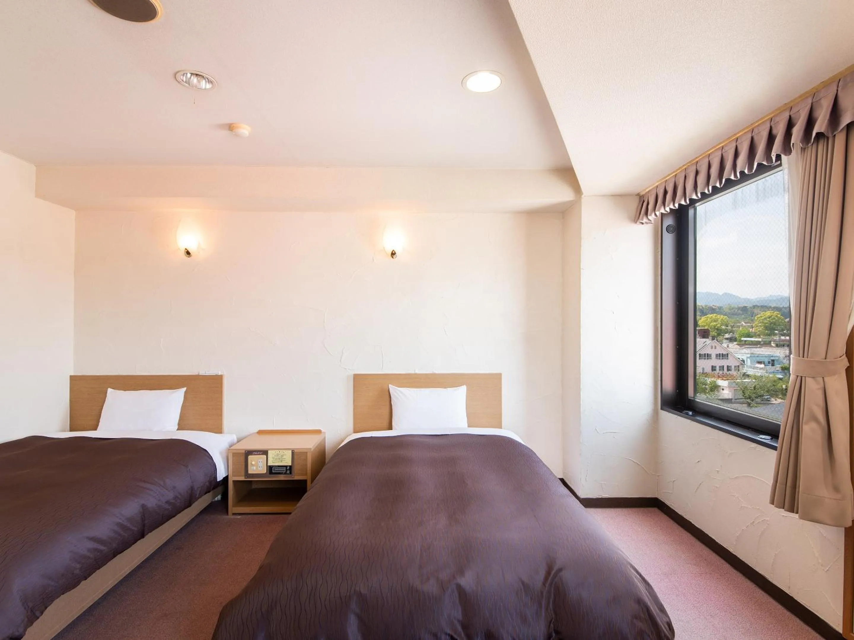 Bed in Hotel Primrose Saito