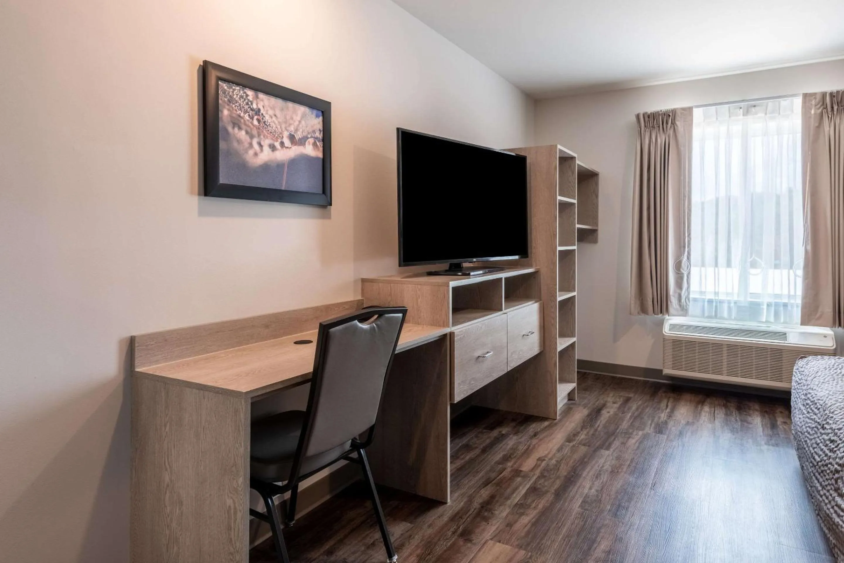 Bedroom in WoodSpring Suites Greensboro - High Point North