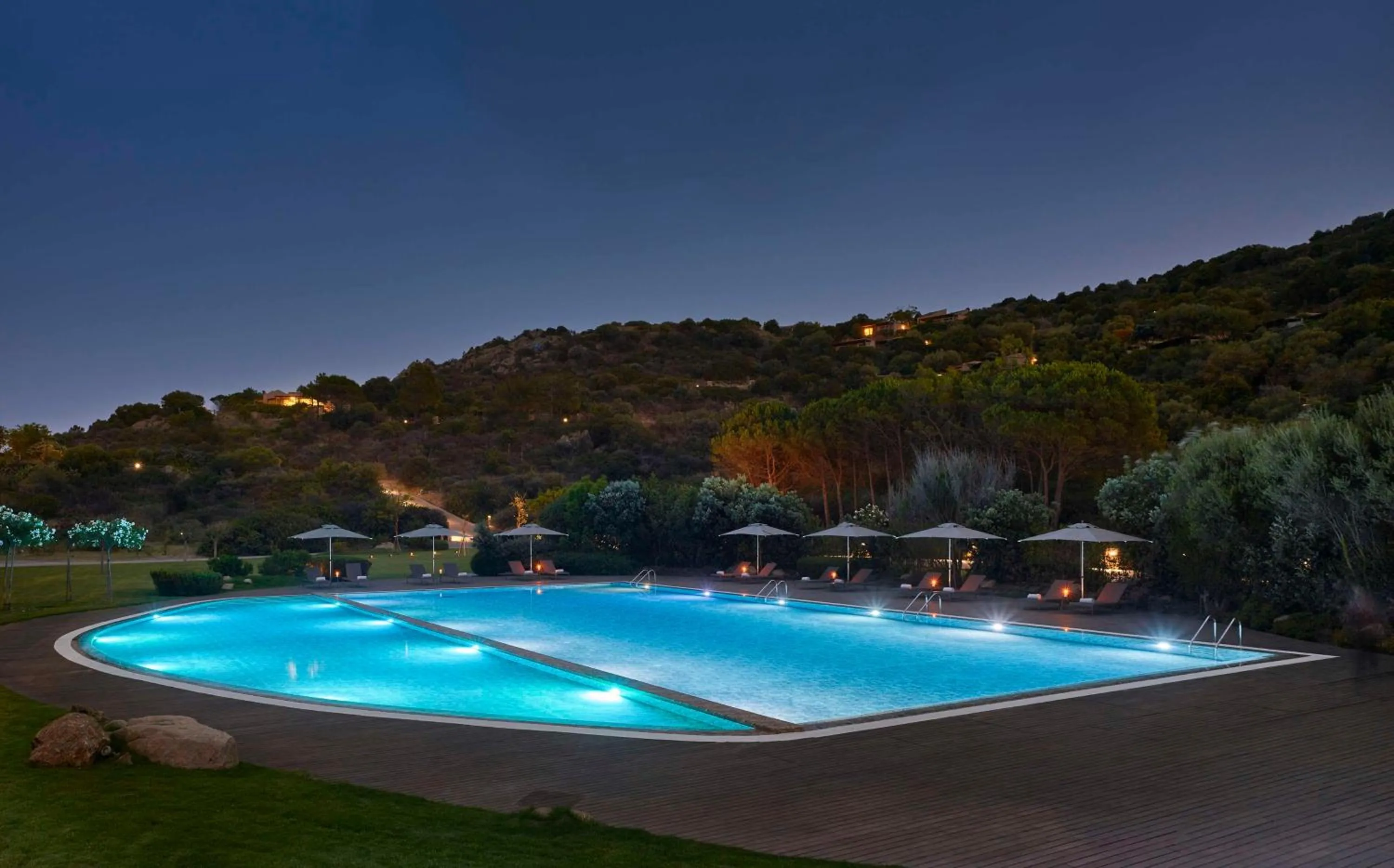 Pool view in Baia Di Chia Resort Sardinia, Curio Collection By Hilton