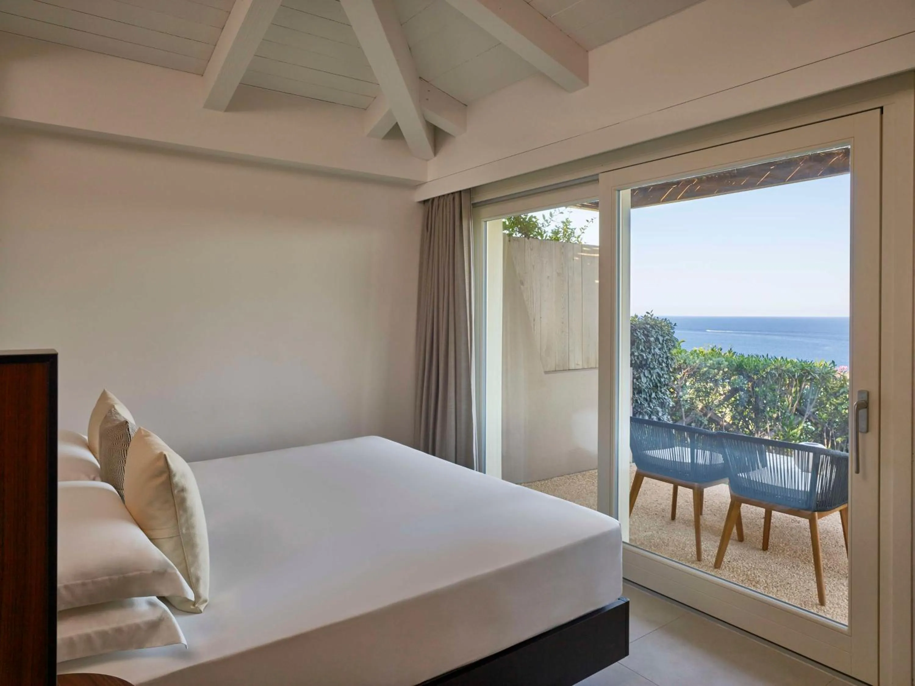 Bed in Baia Di Chia Resort Sardinia, Curio Collection By Hilton