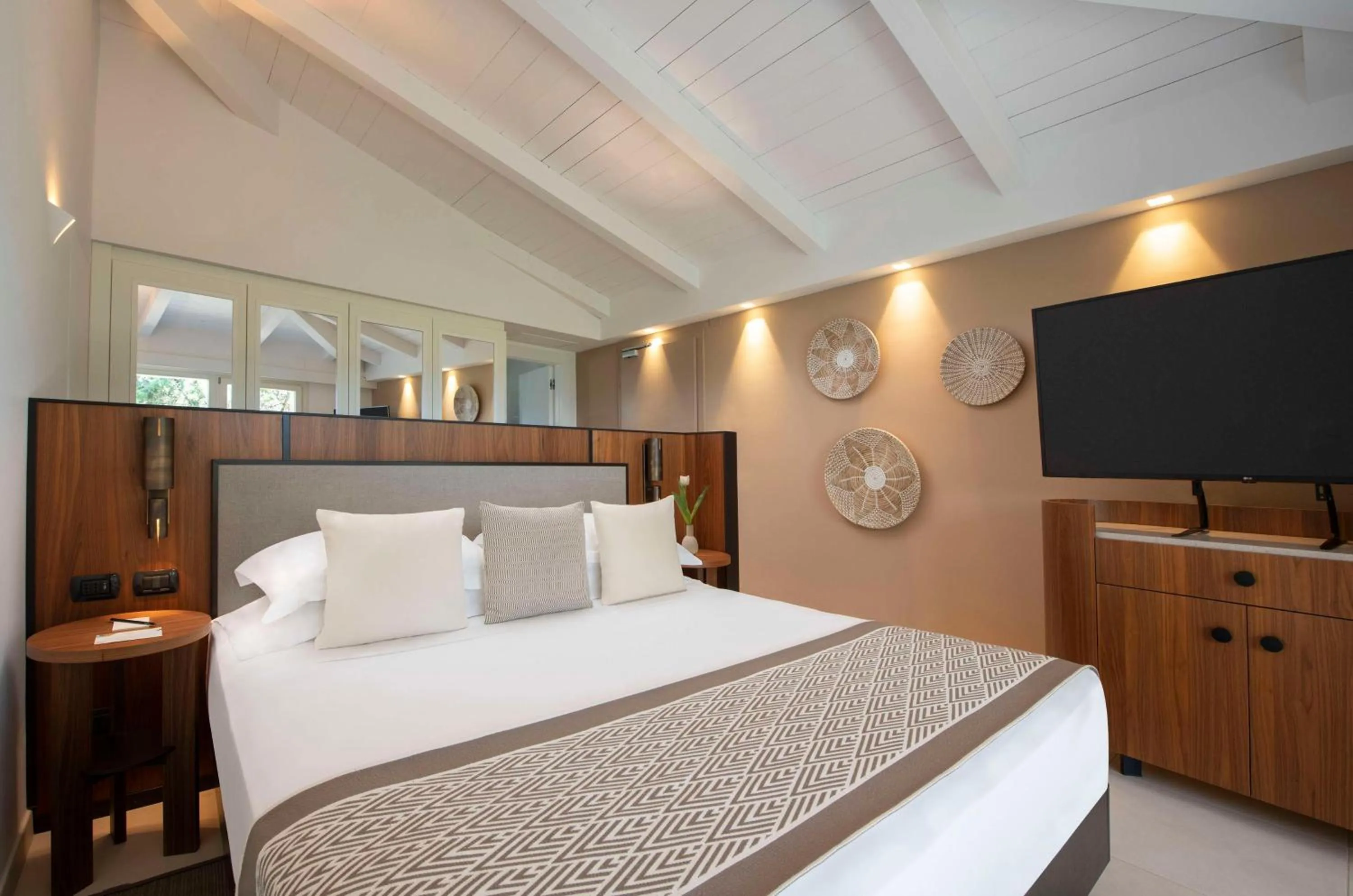 Bed in Baia Di Chia Resort Sardinia, Curio Collection By Hilton